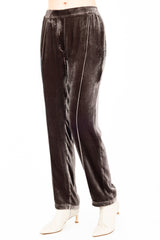 Brown velvet pants worn by a model on a white background
