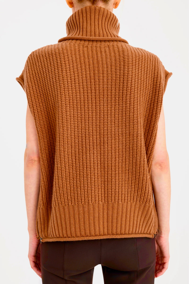 Brown knitted vest worn by a person on a white background