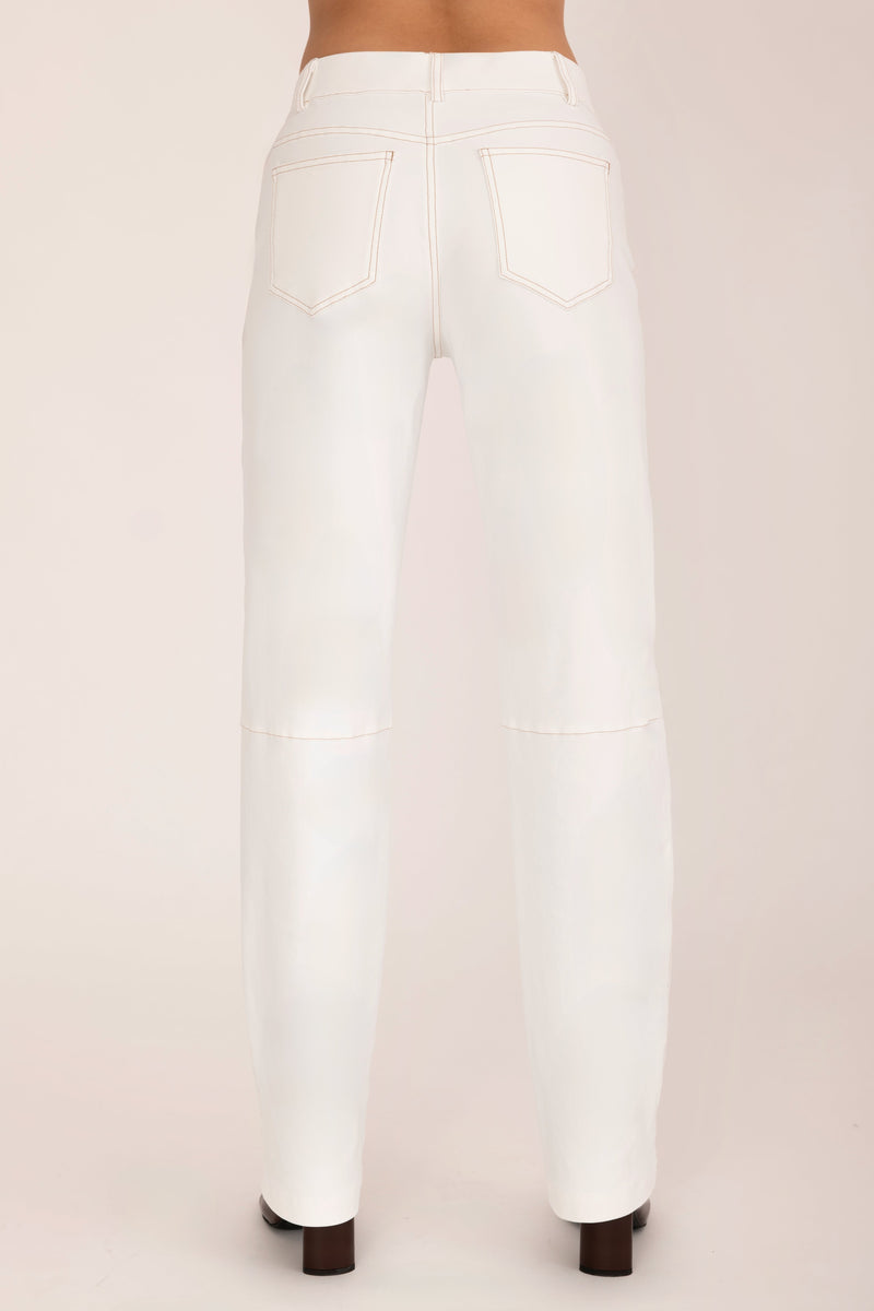 White pants worn by a person on a plain background