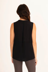 Woman wearing a black sleeveless top on a white background