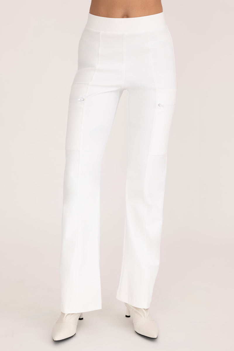 White pants worn by a person on a light pink background