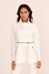 Woman wearing a white jacket on a light pink background