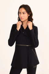 Woman wearing a black coat on a white background
