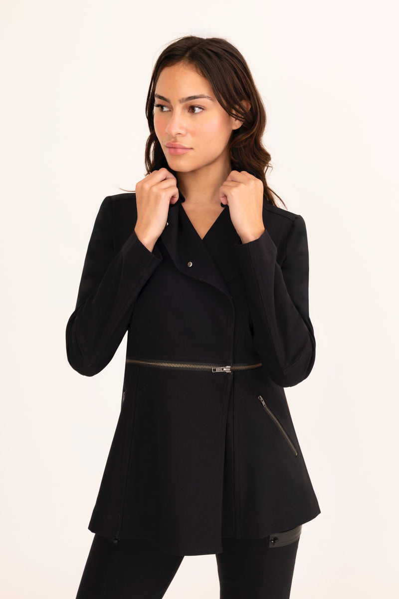 Woman wearing a black coat on a white background