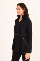 Woman wearing a black coat with zippers on a white background