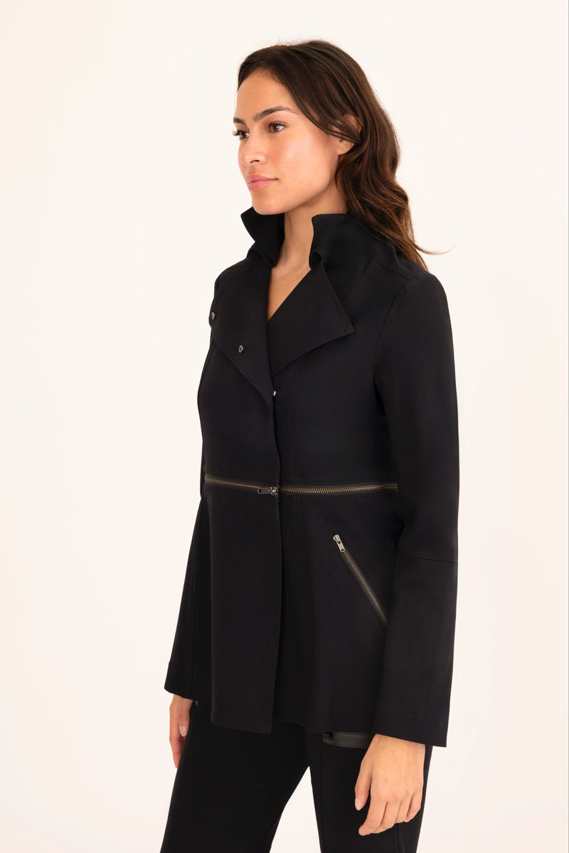 Woman wearing a black coat with zippers on a white background