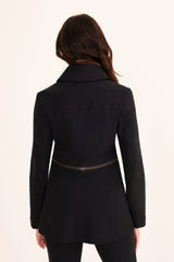Black coat worn by a person on a white background