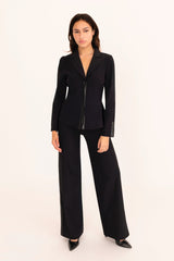 Woman wearing a black suit on a white background