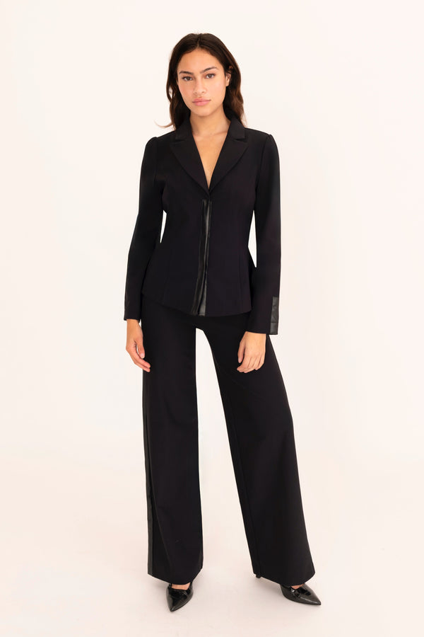 Woman wearing a black suit on a white background