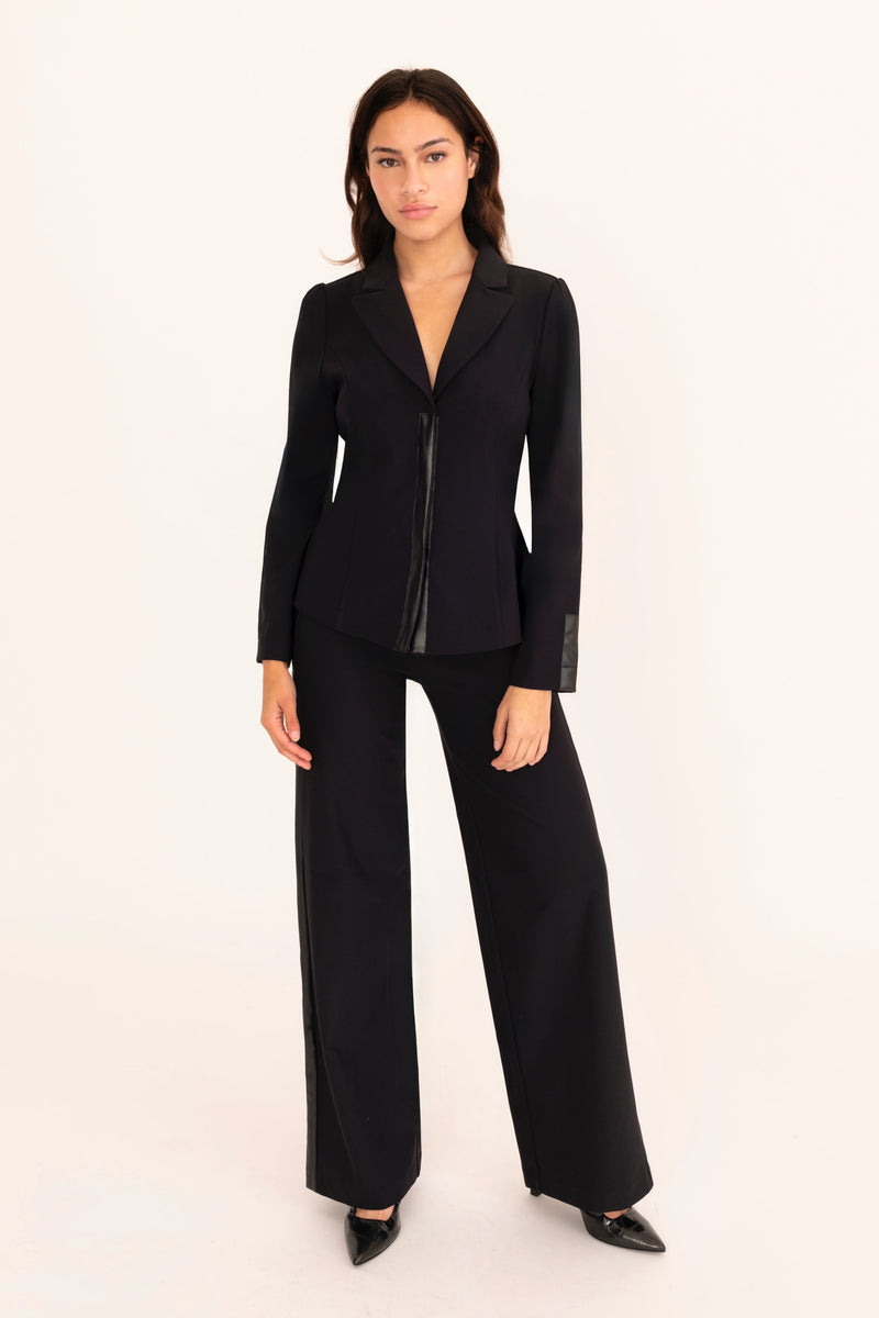 Woman wearing a black suit on a white background