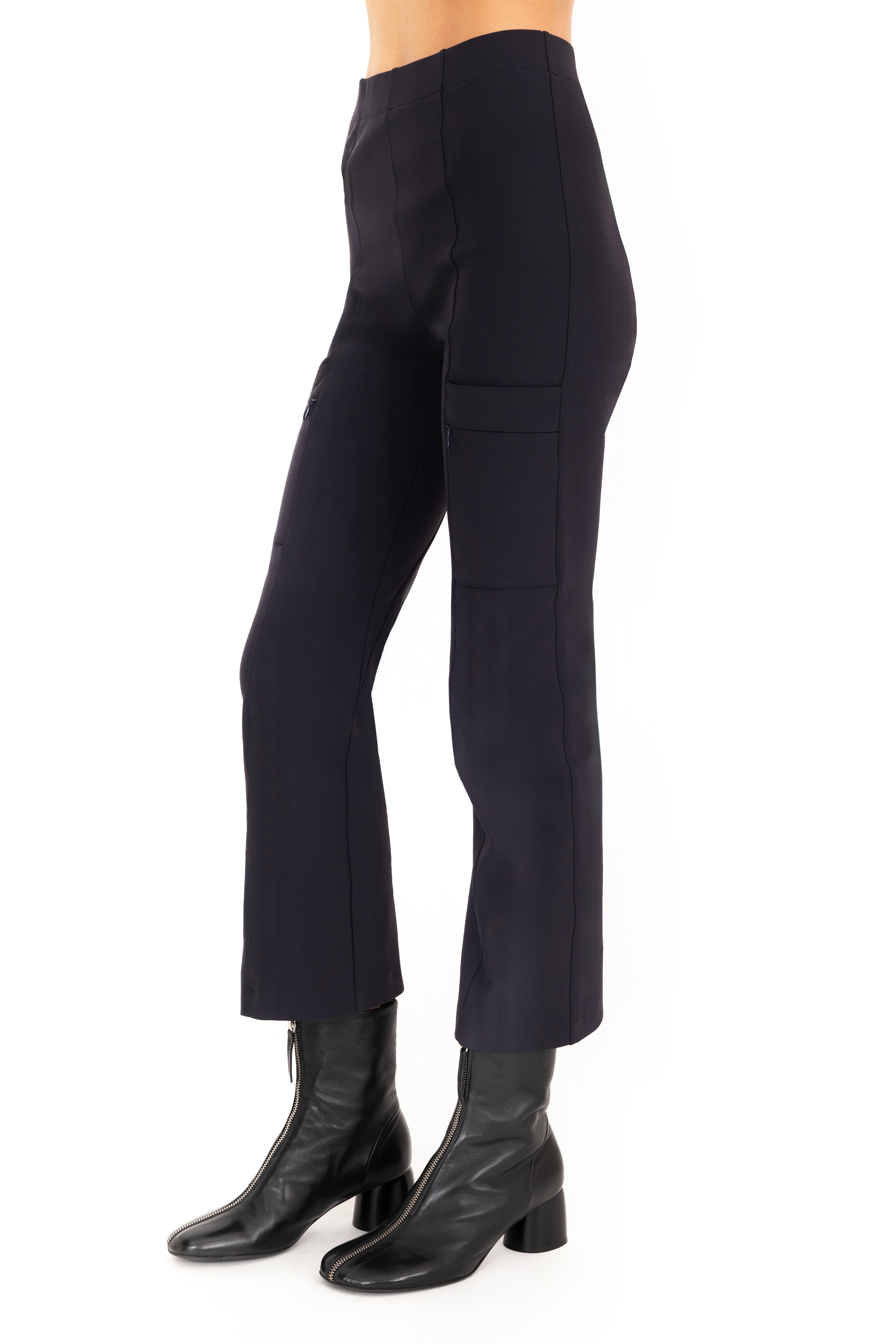 Dark blue pants worn by a person on a white background