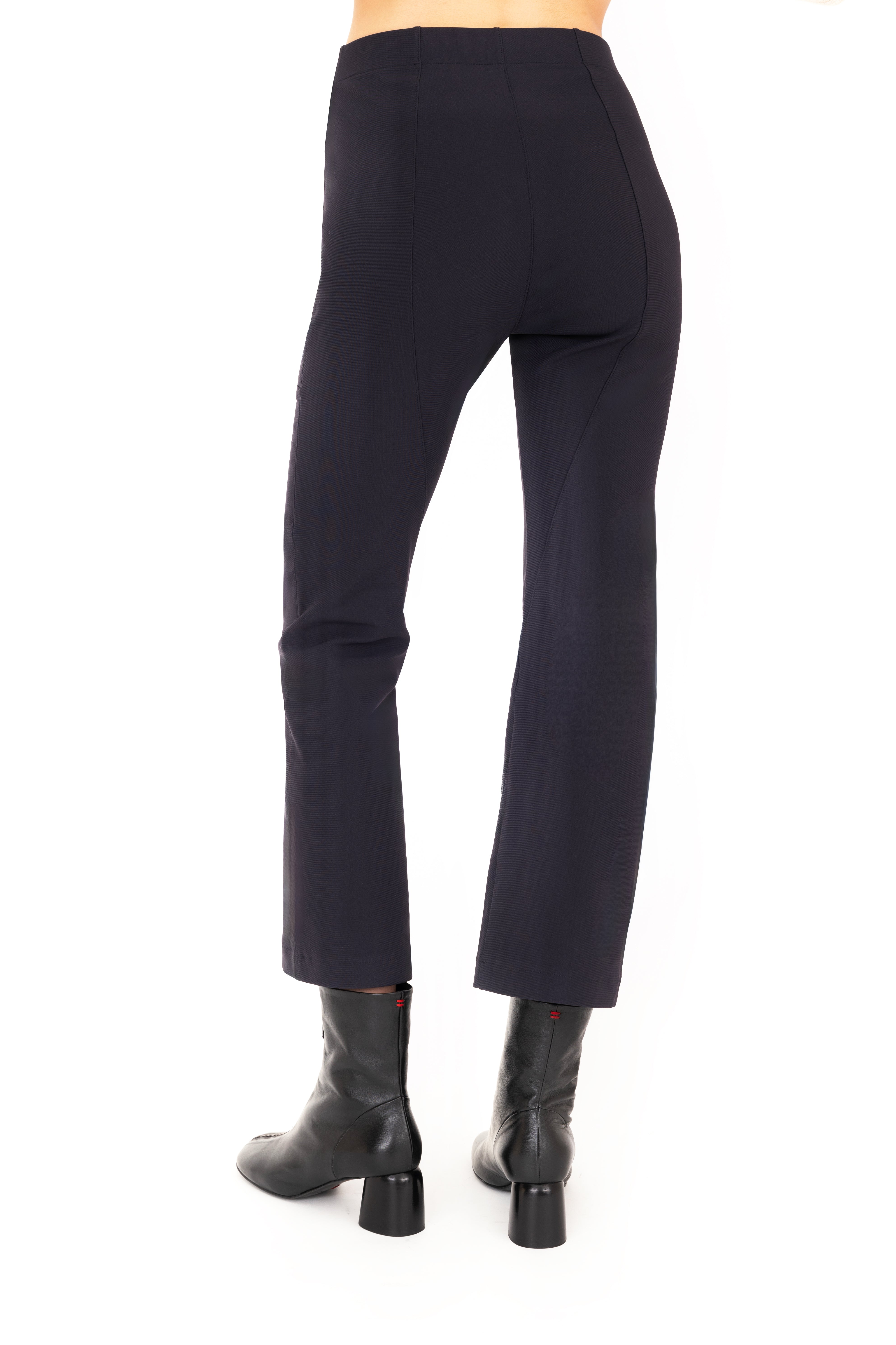 Dark blue pants worn by a person on a white background