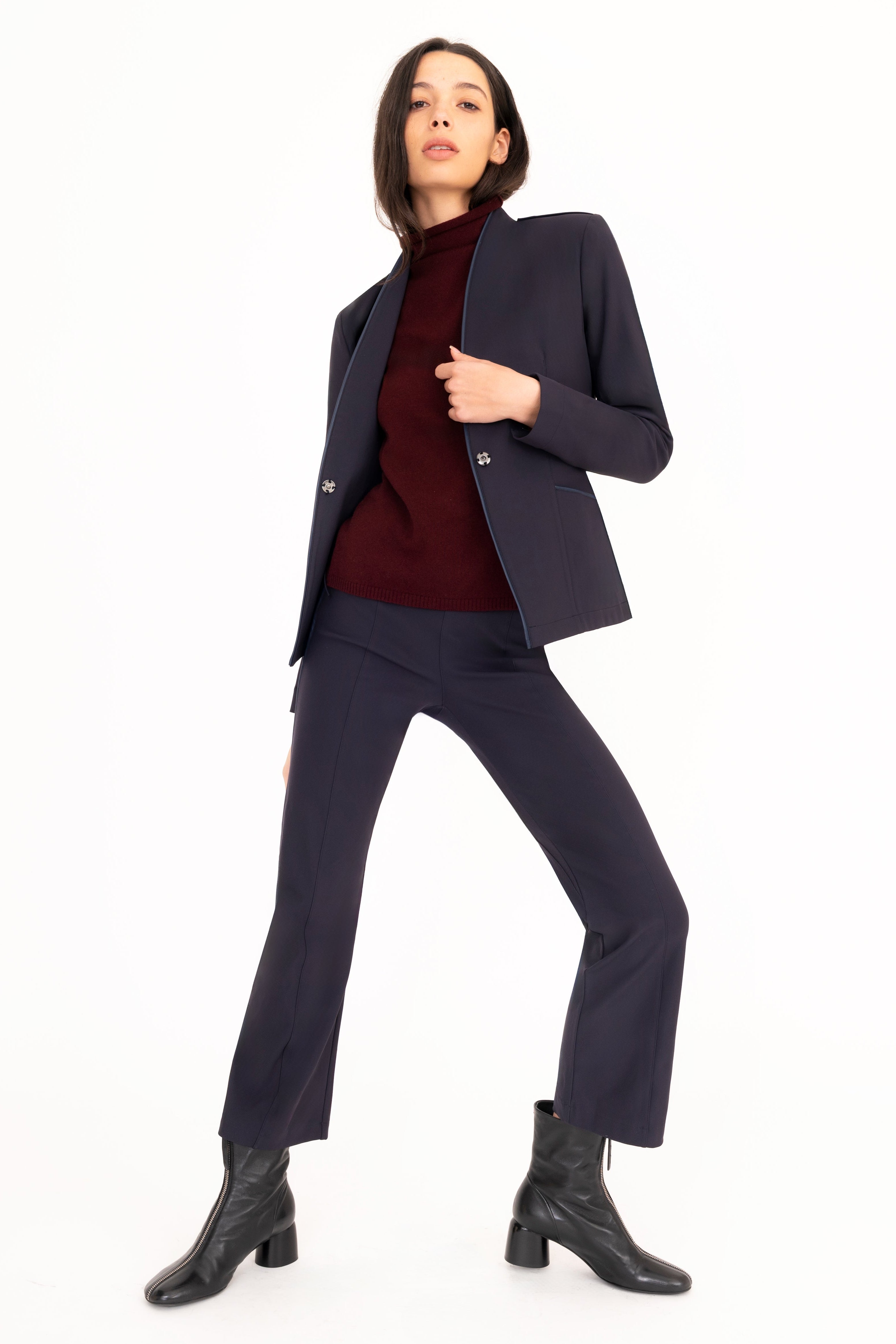 Woman wearing a dark suit with a white background