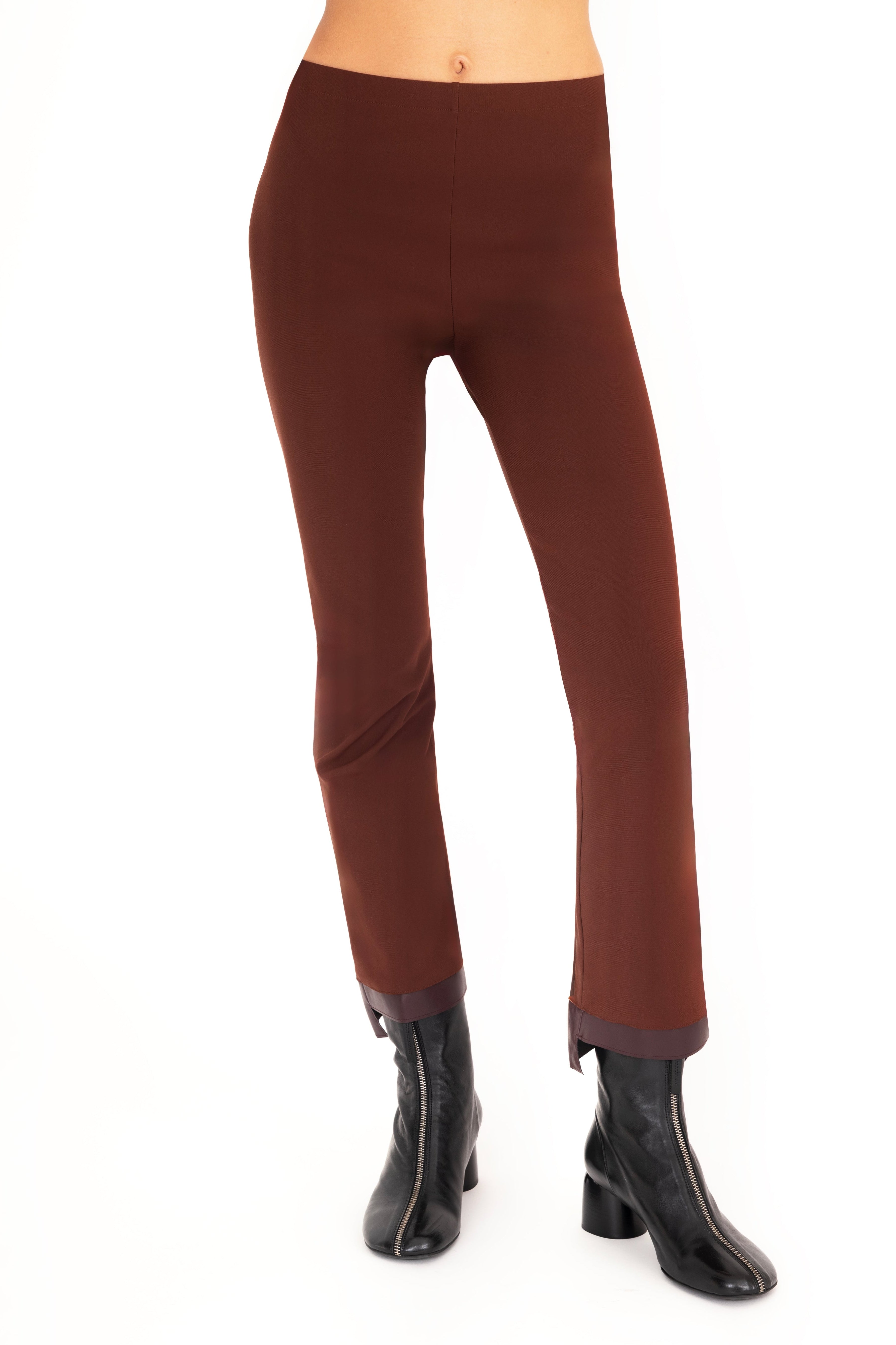 Brown pants worn by a person on a white background