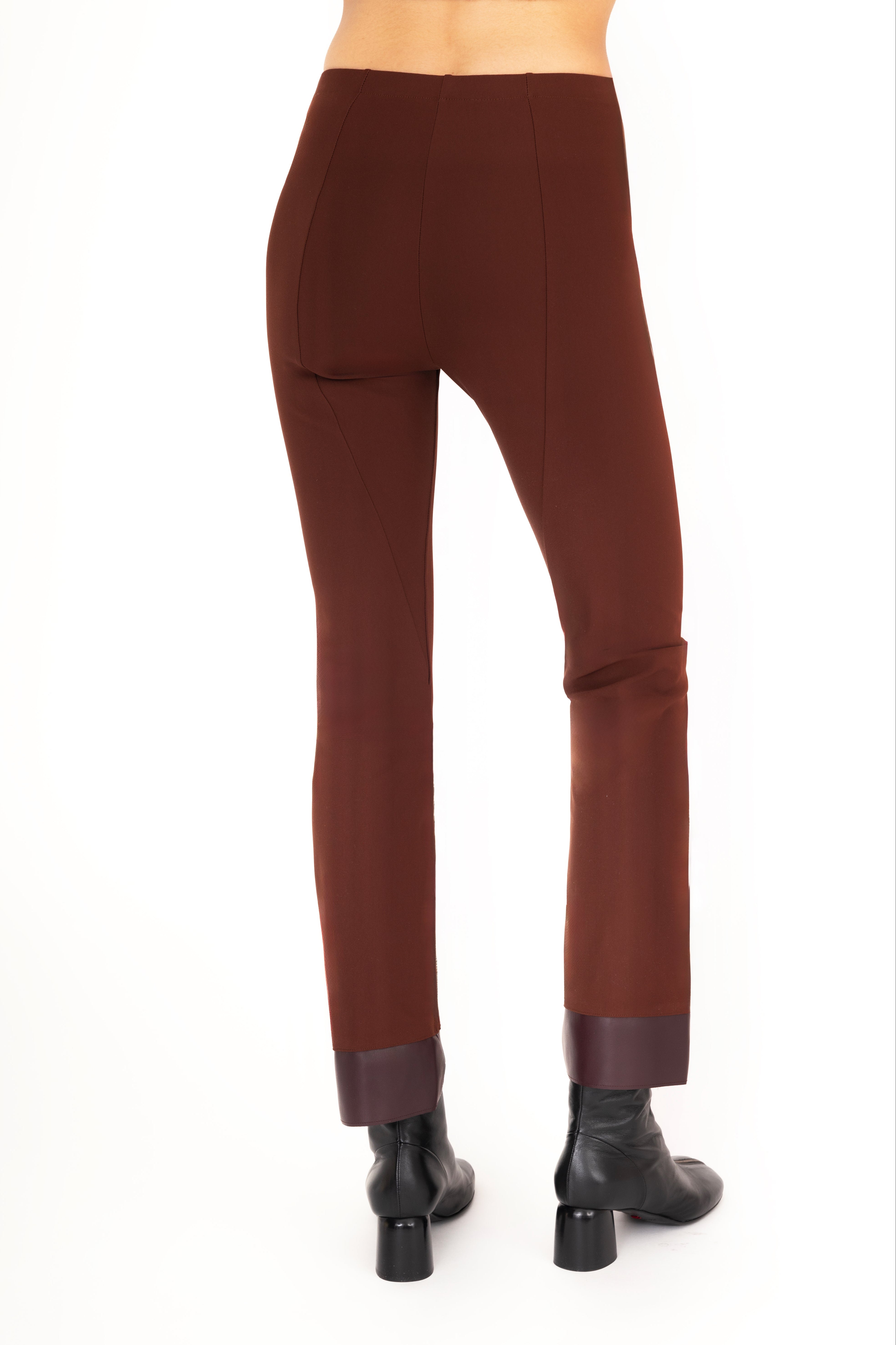 Brown pants worn by a person on a white background