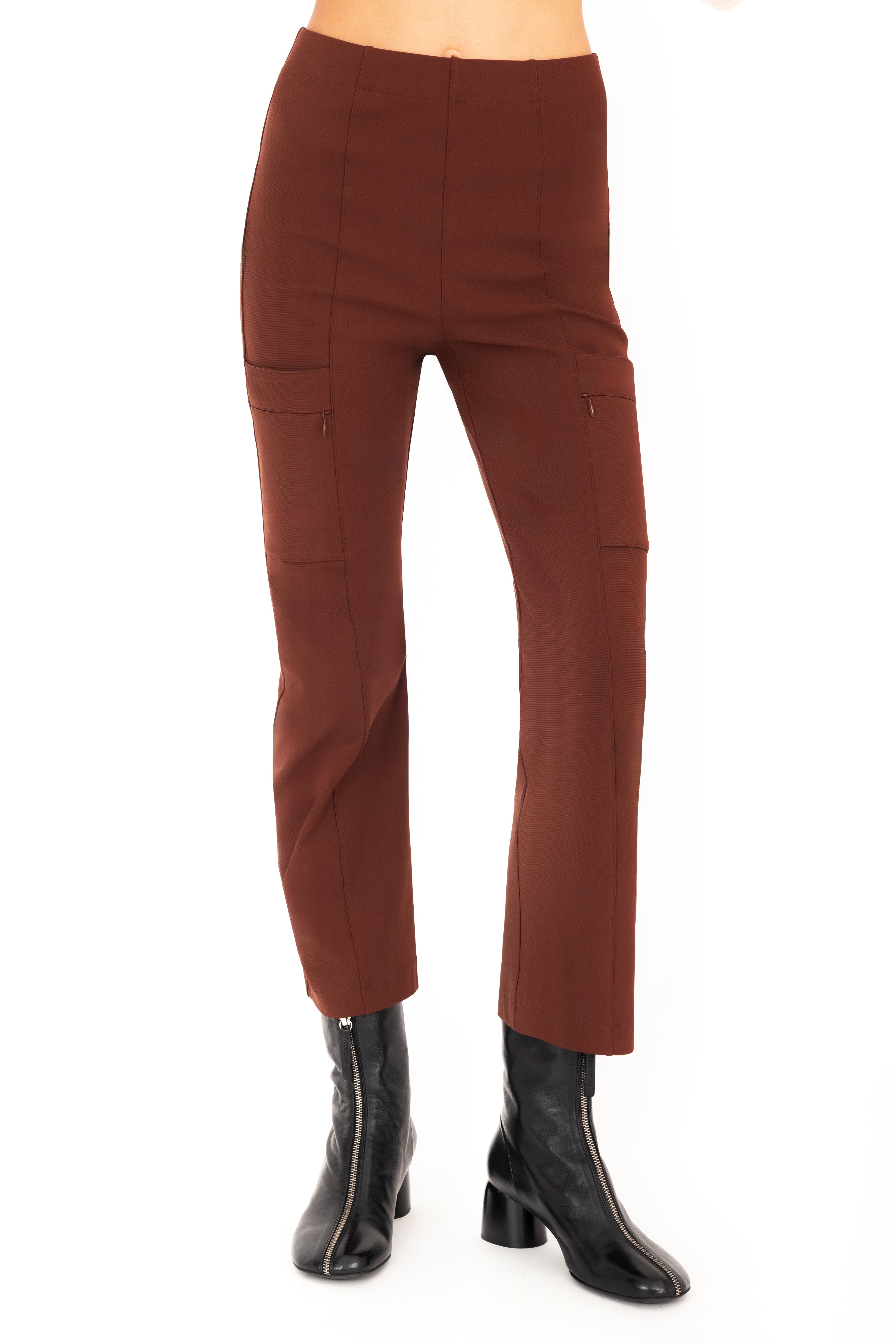 Brown pants worn with black boots on a white background