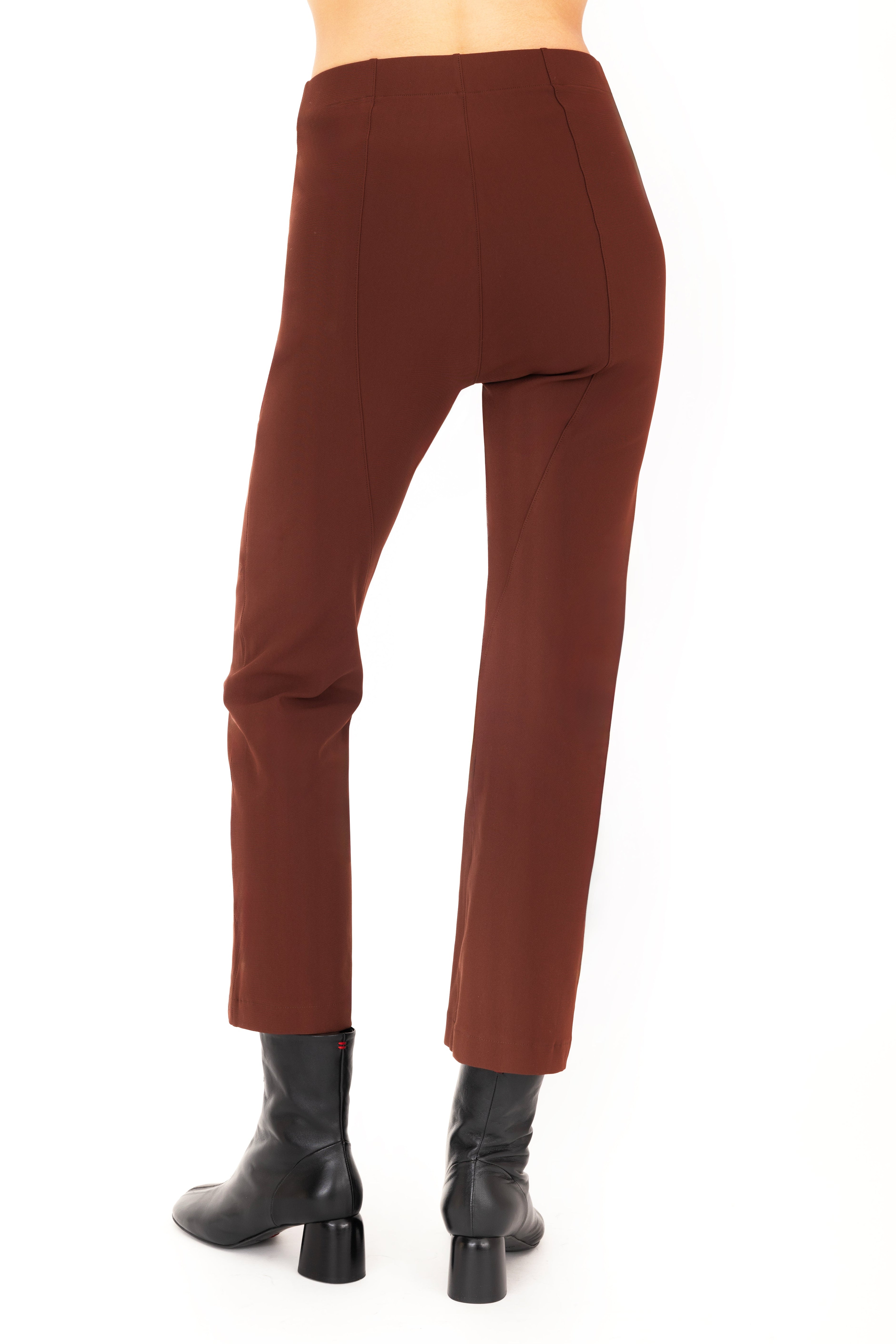 Brown pants worn by a person on a white background