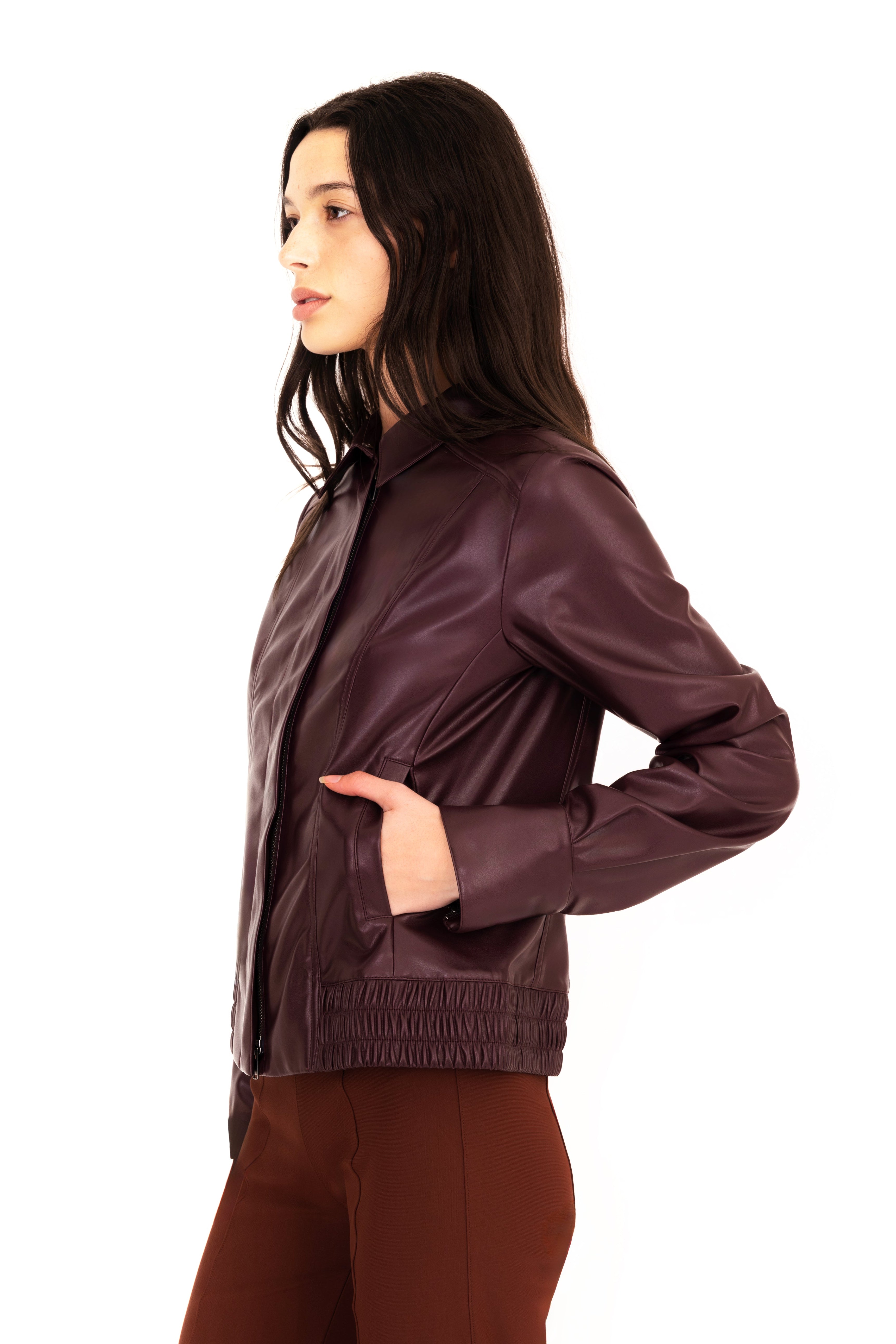 Woman wearing a brown leather jacket on a white background