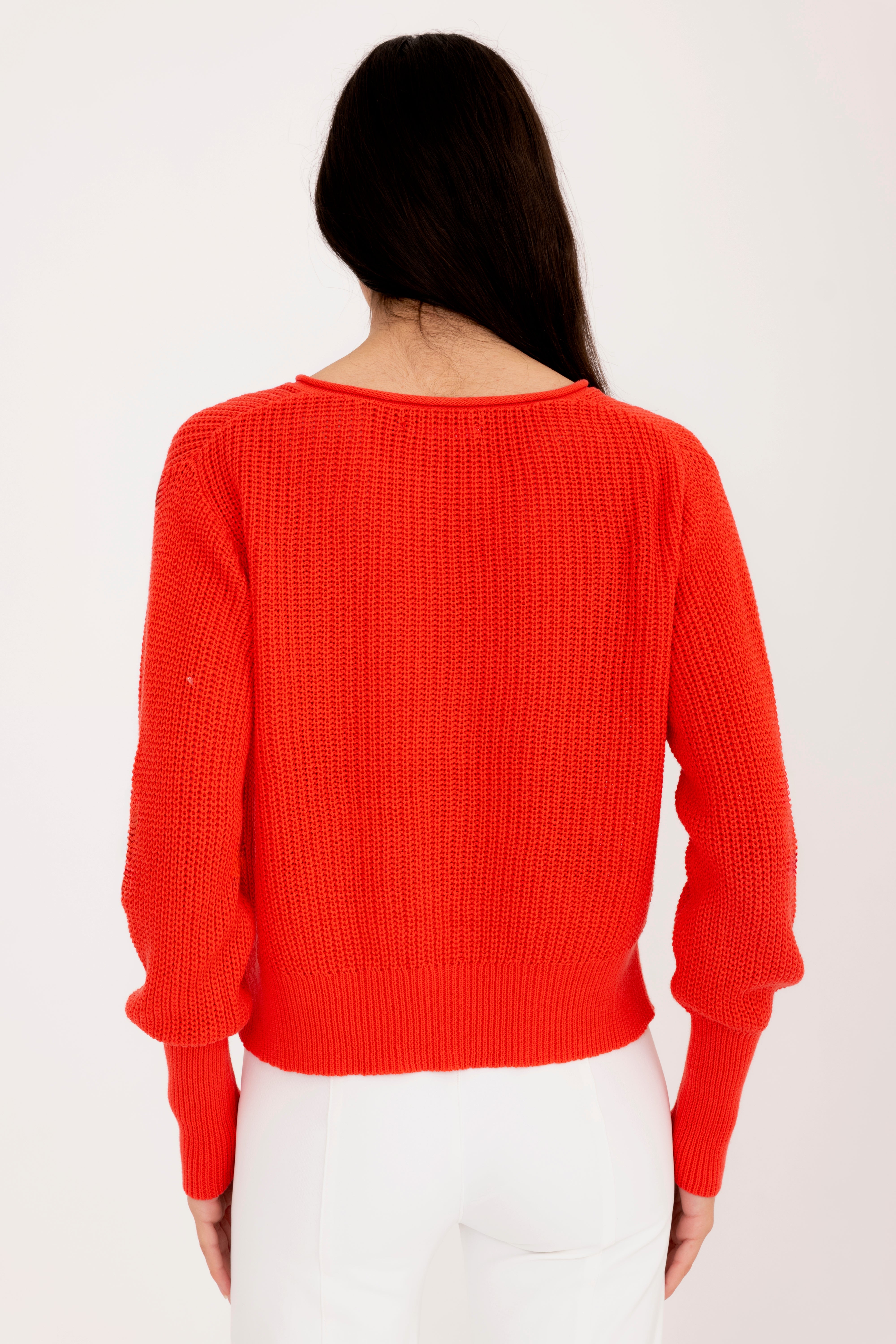 Person wearing a orange sweater on a white background