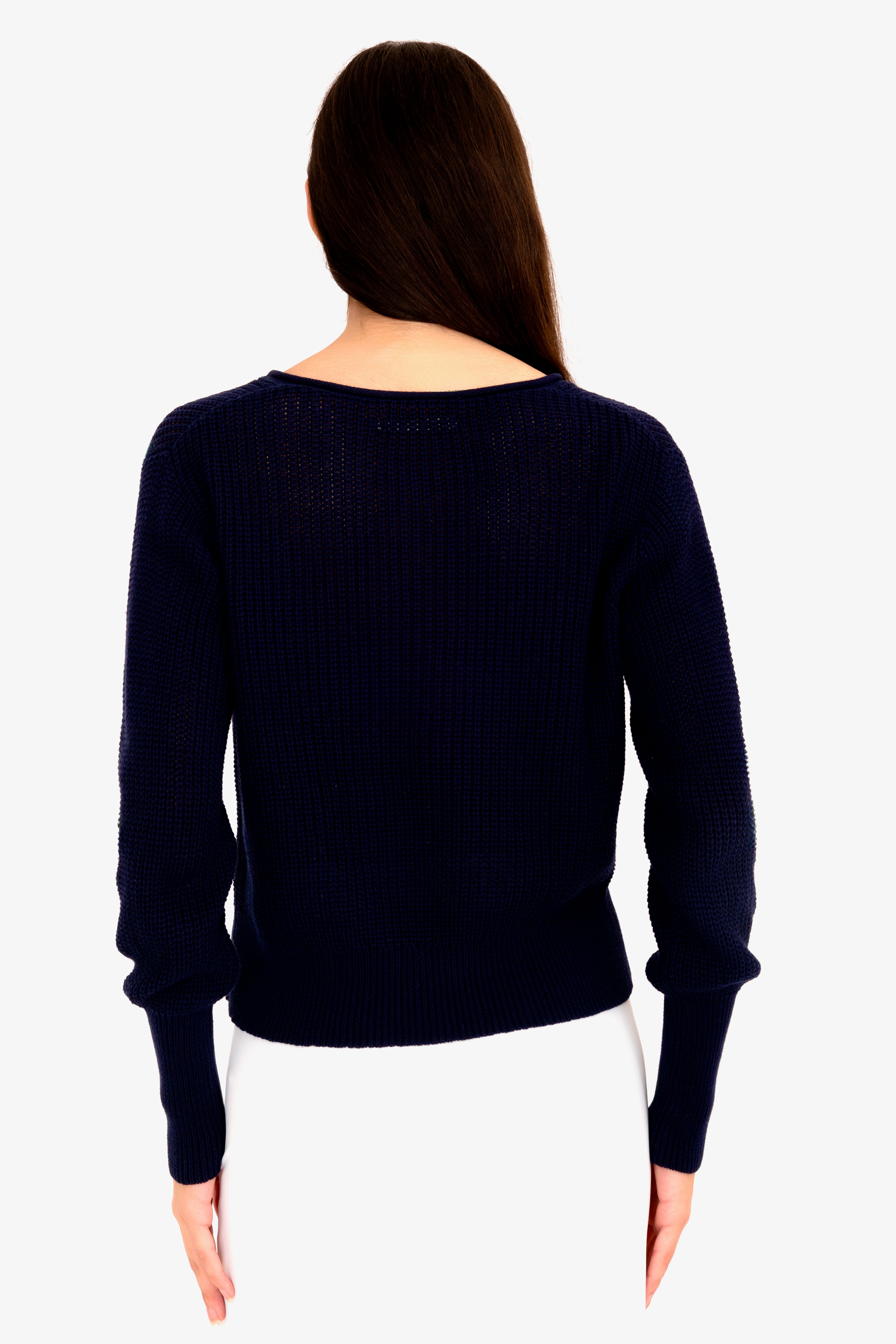 Person wearing a navy blue sweater on a white background