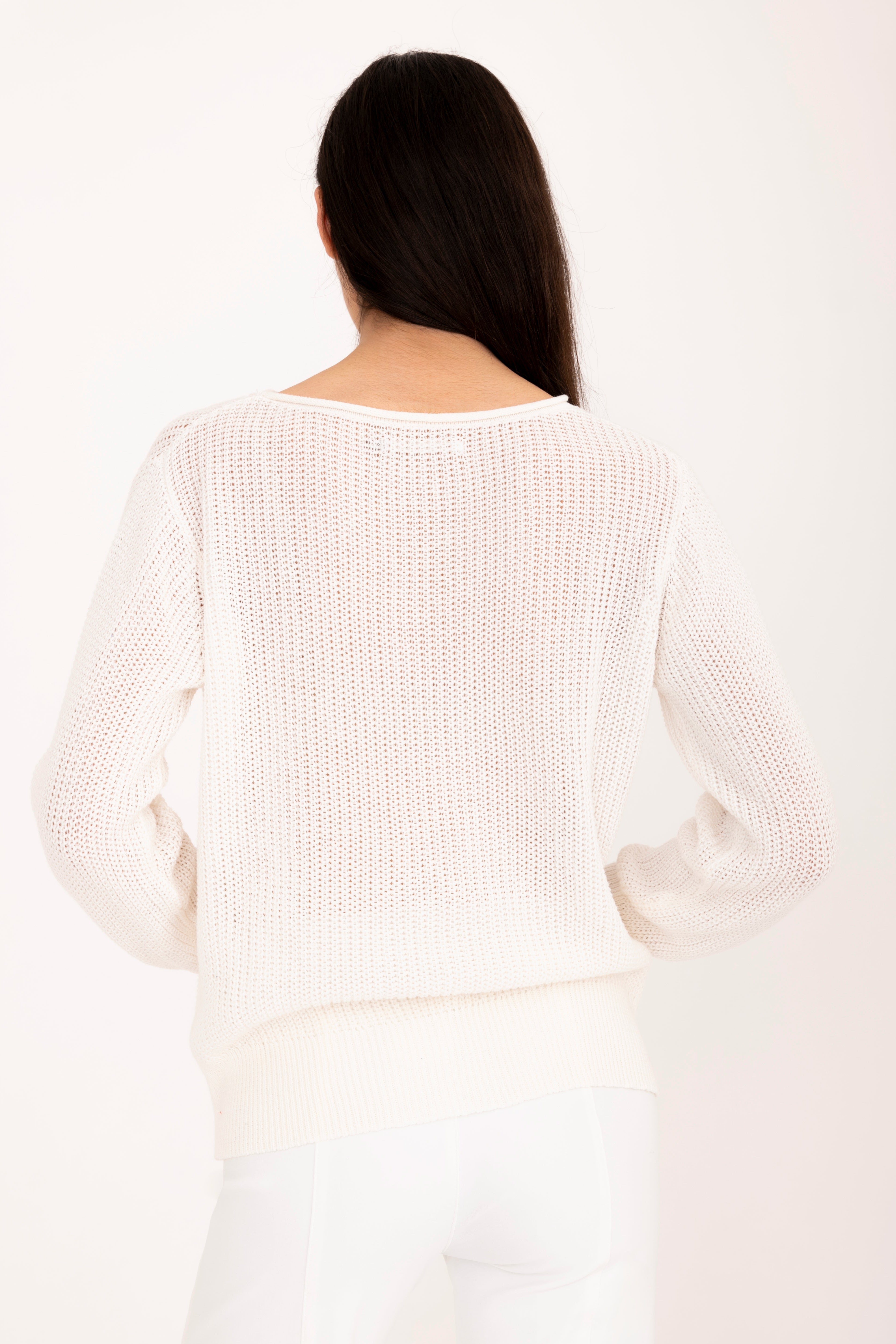 Woman wearing a white sweater on a white background
