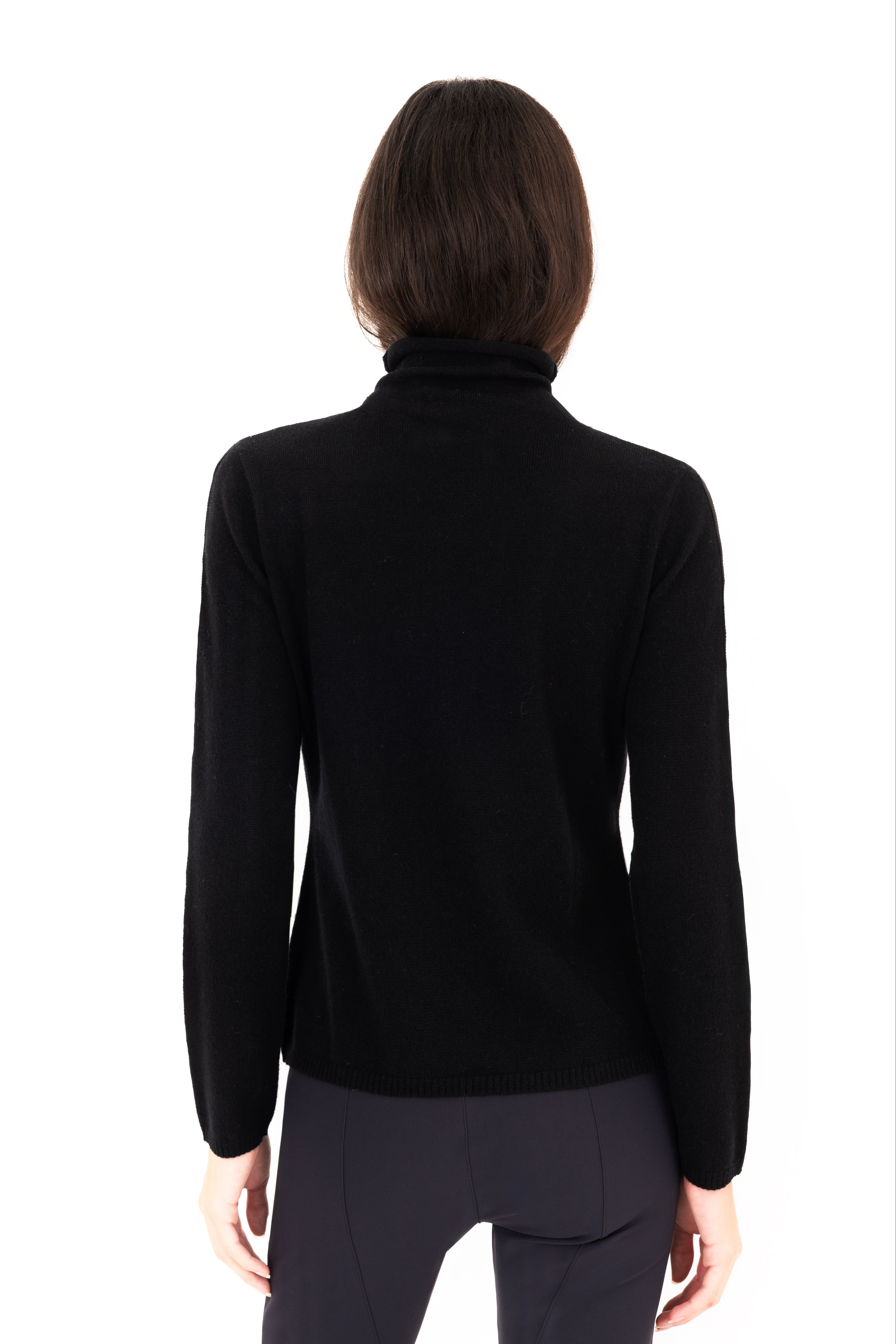 Woman wearing a black turtleneck sweater on a white background