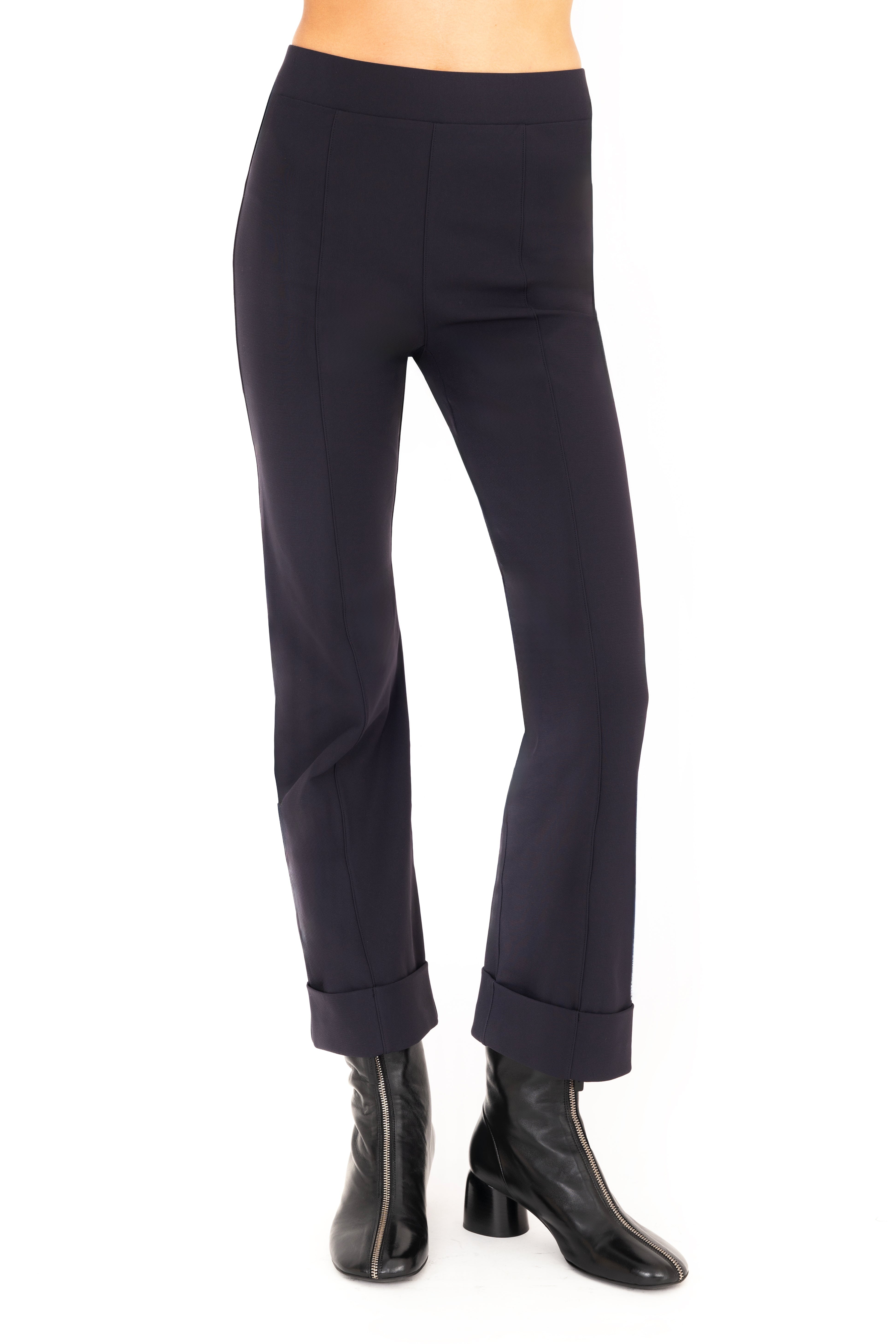 Dark blue pants worn by a person on a white background