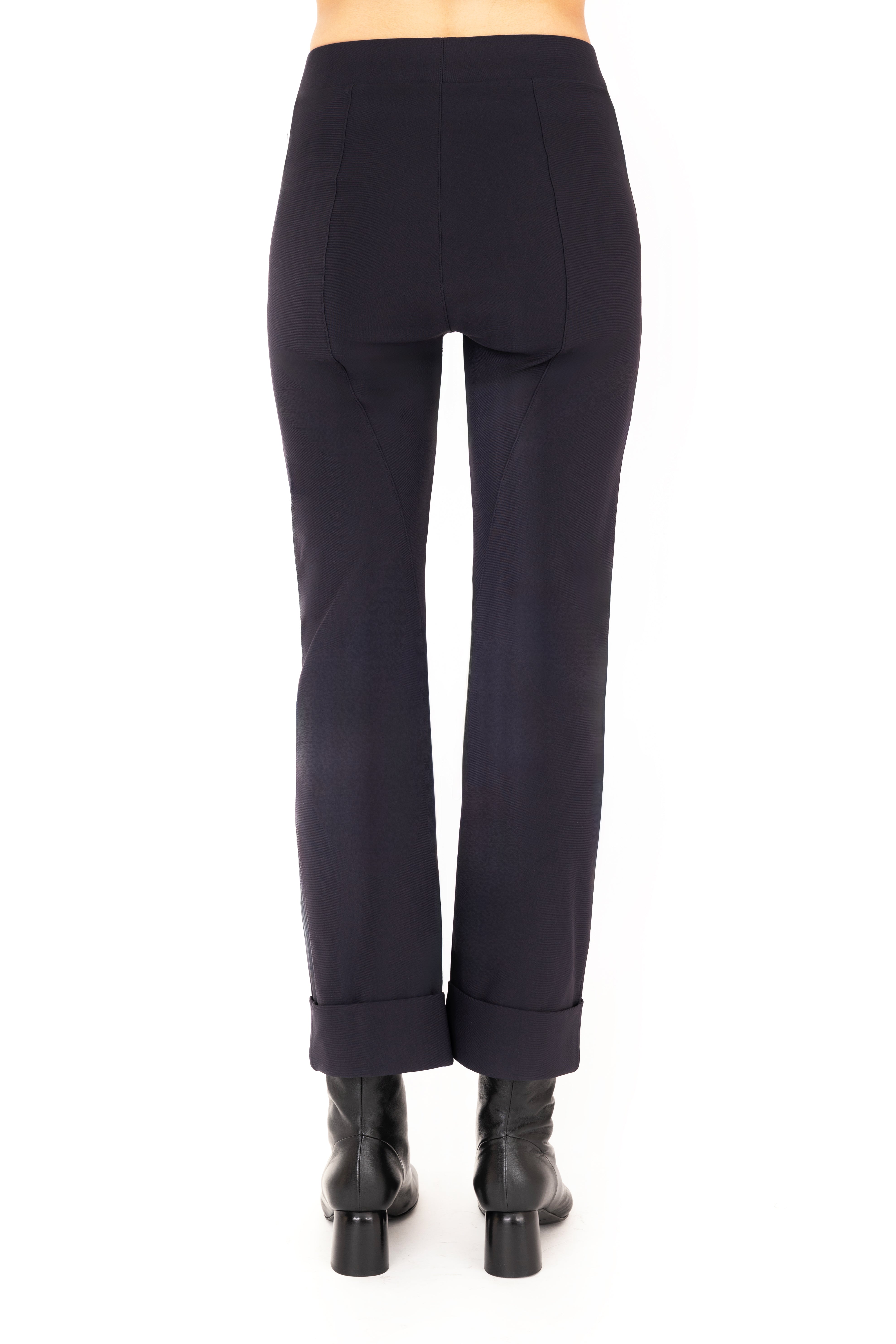 Dark blue pants worn by a person on a white background