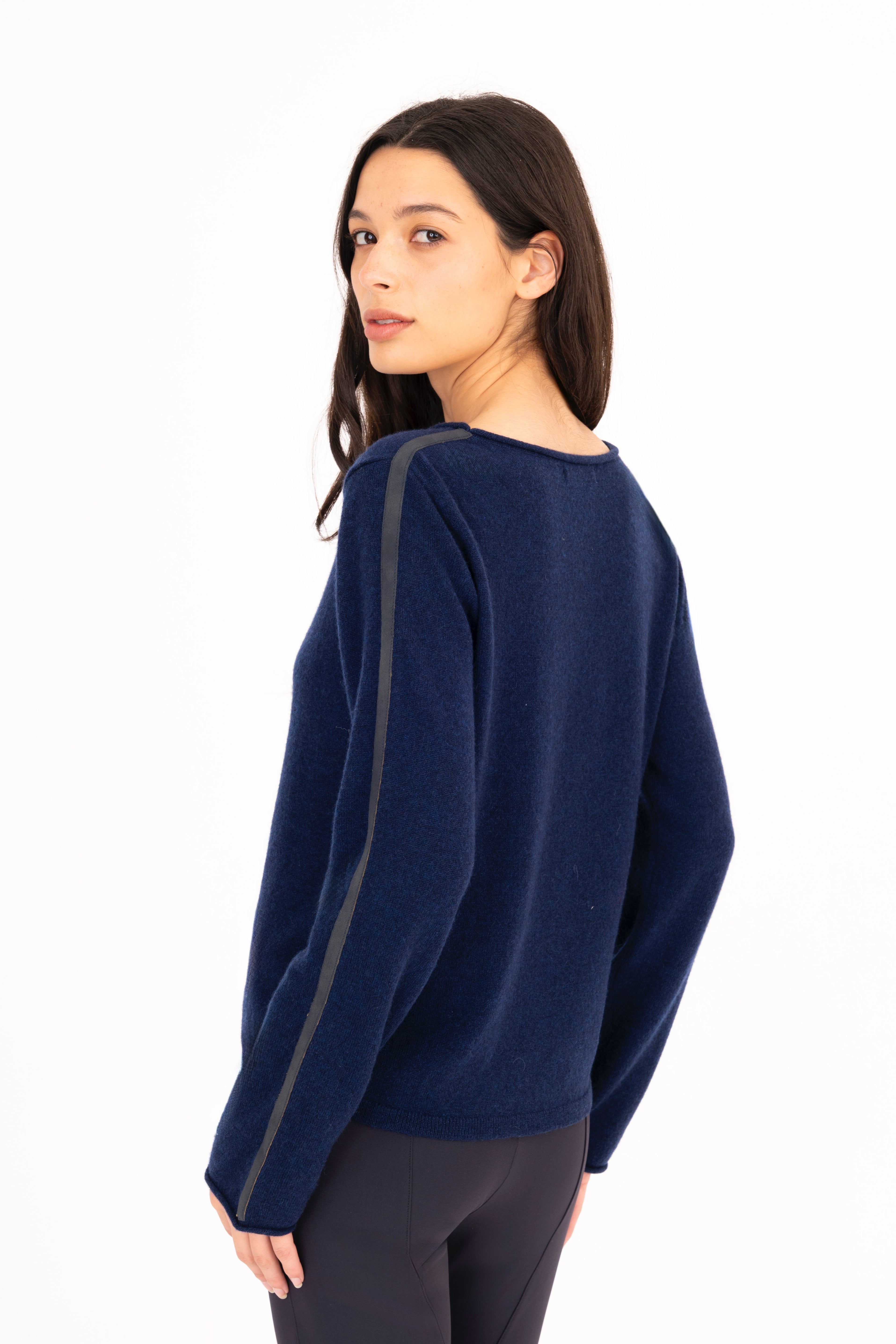 Woman wearing a blue sweater on a white background