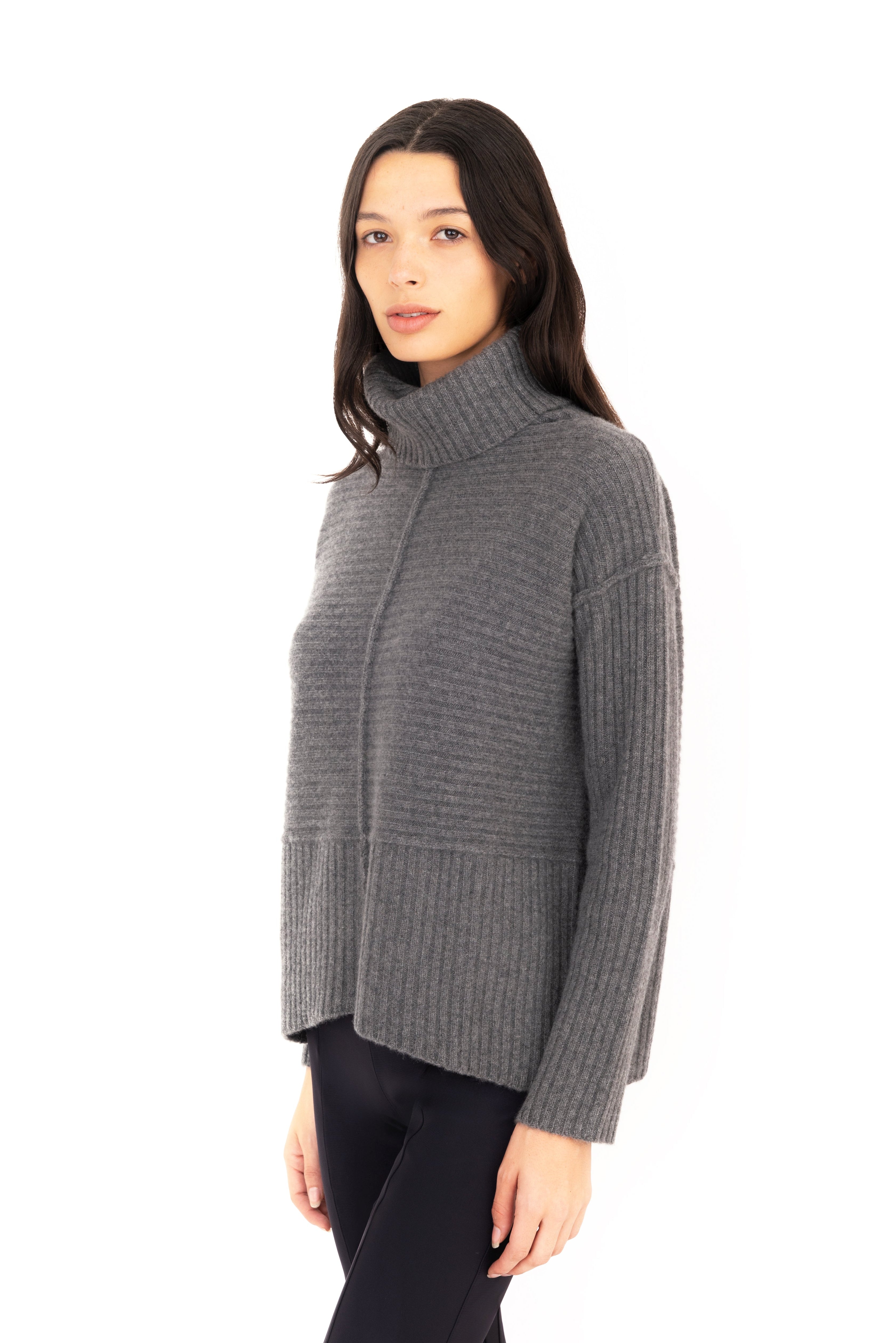Woman wearing a gray sweater on a white background