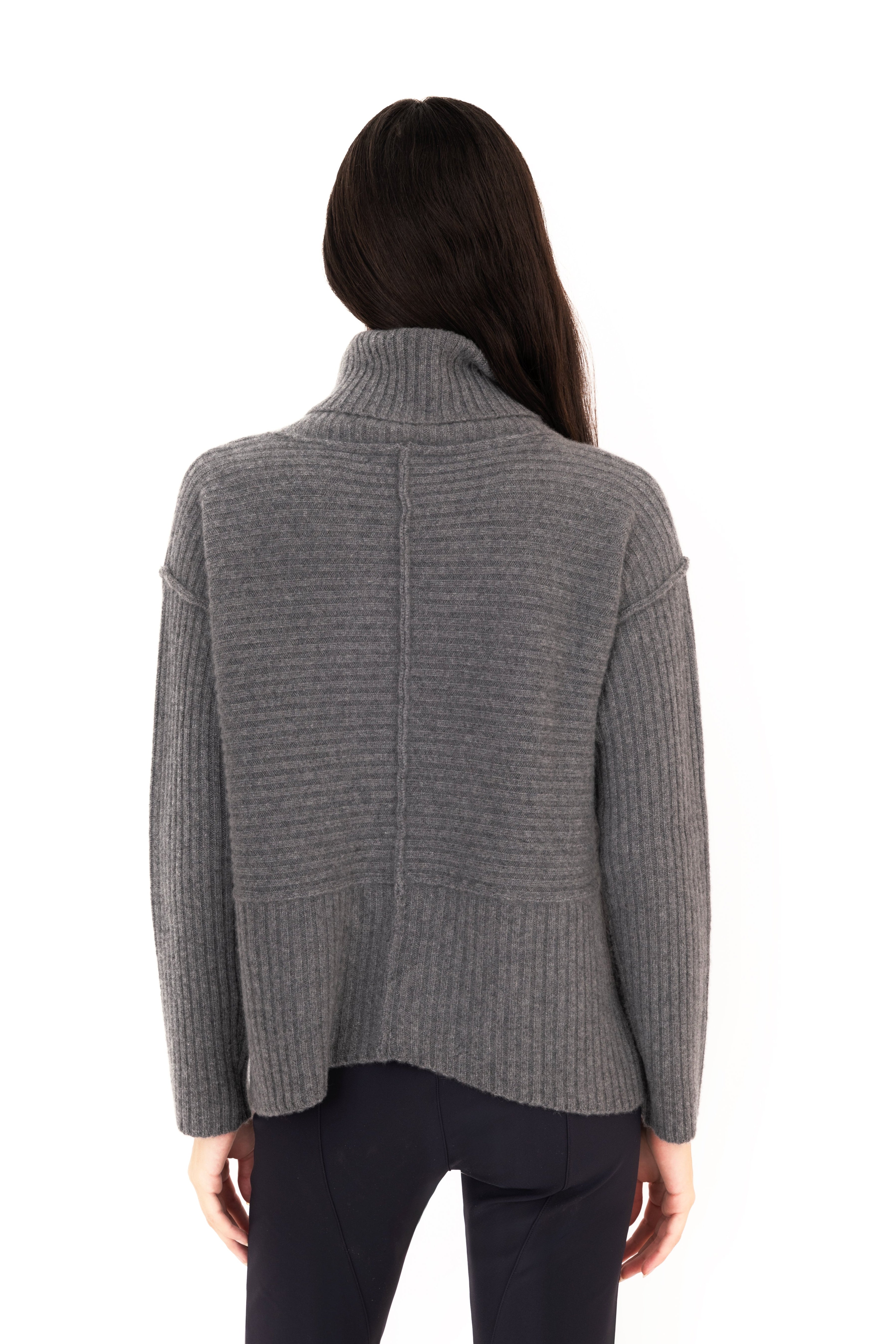 Woman wearing a gray sweater on a white background