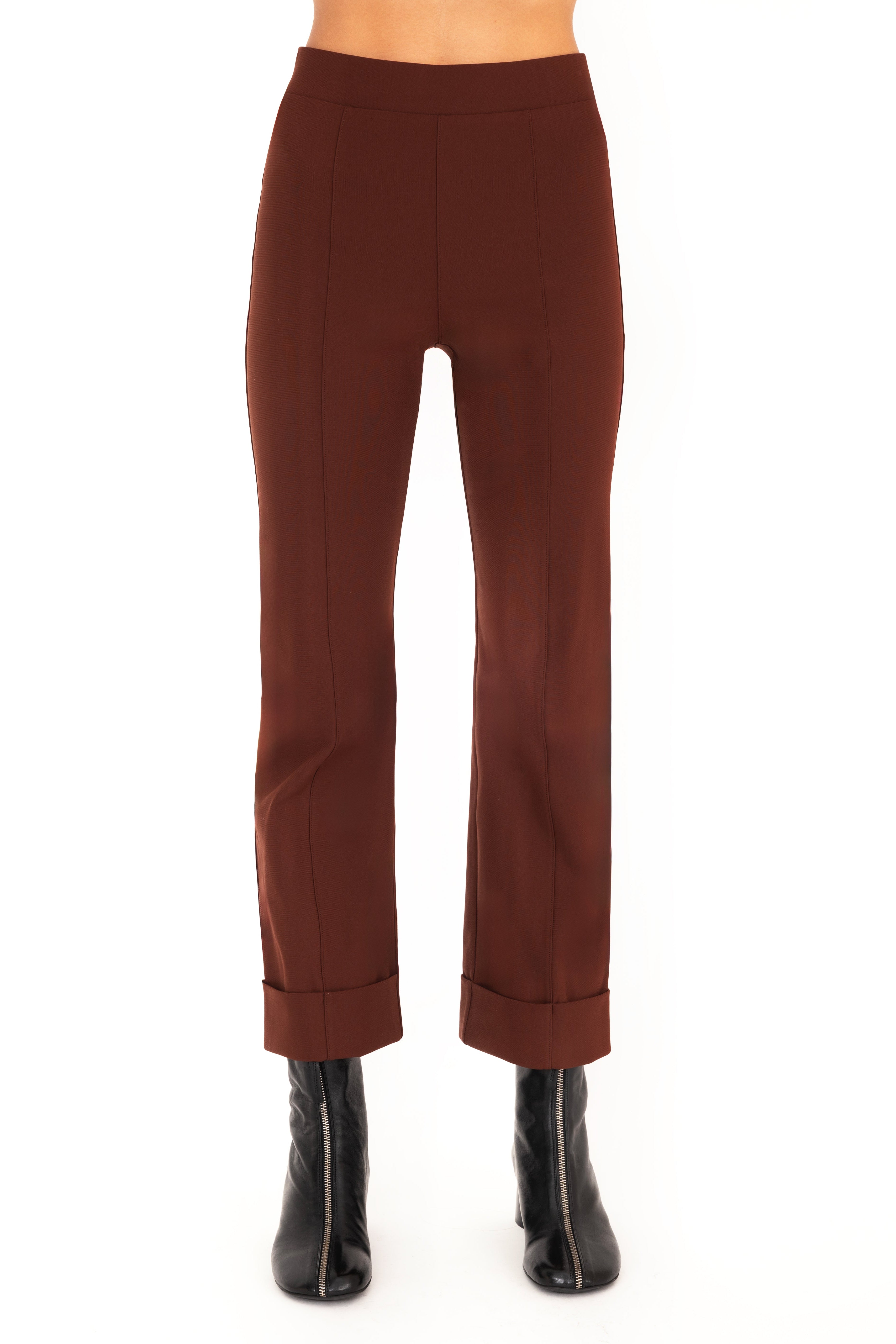 Brown pants worn by a person on a white background