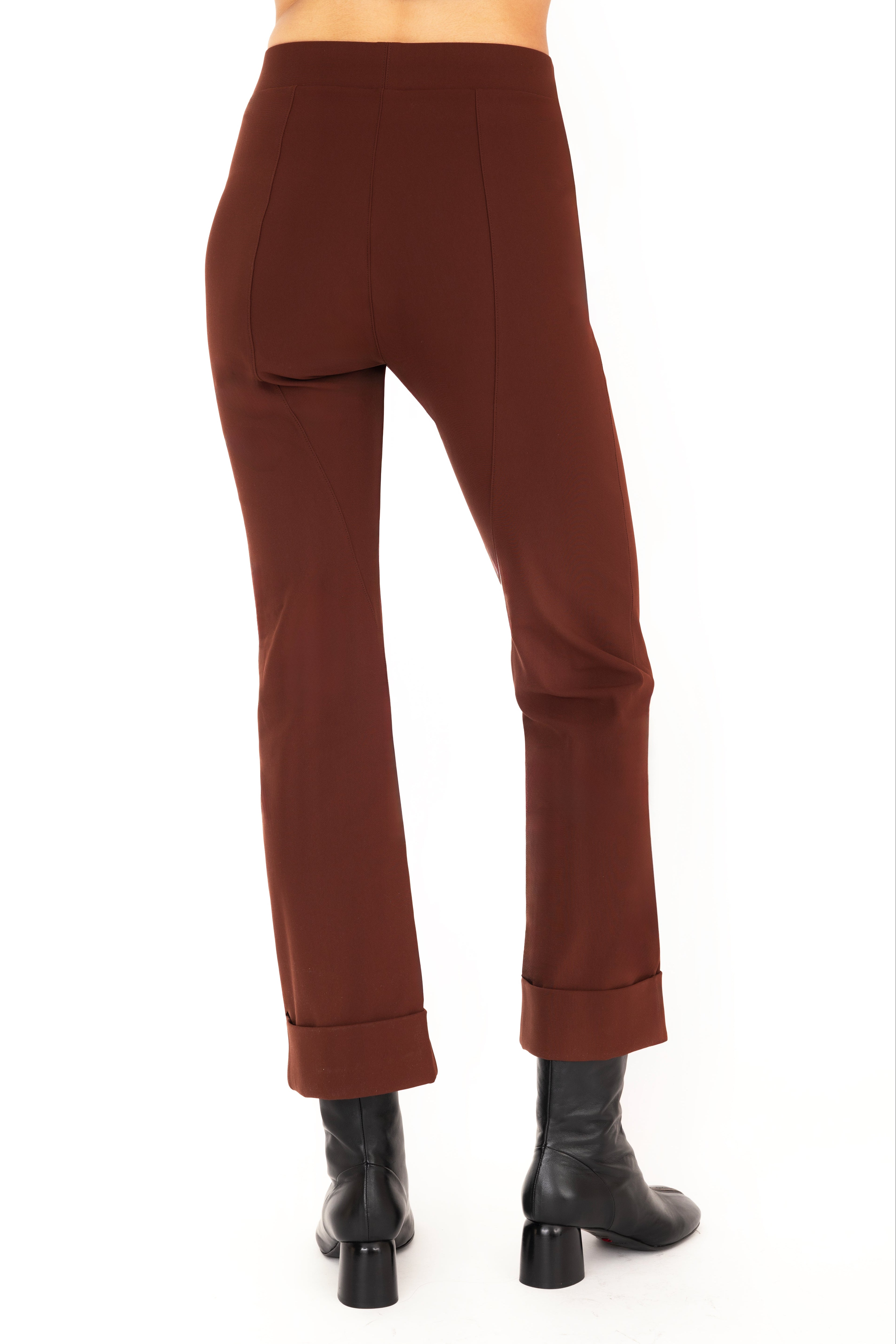 Brown pants worn by a person on a white background