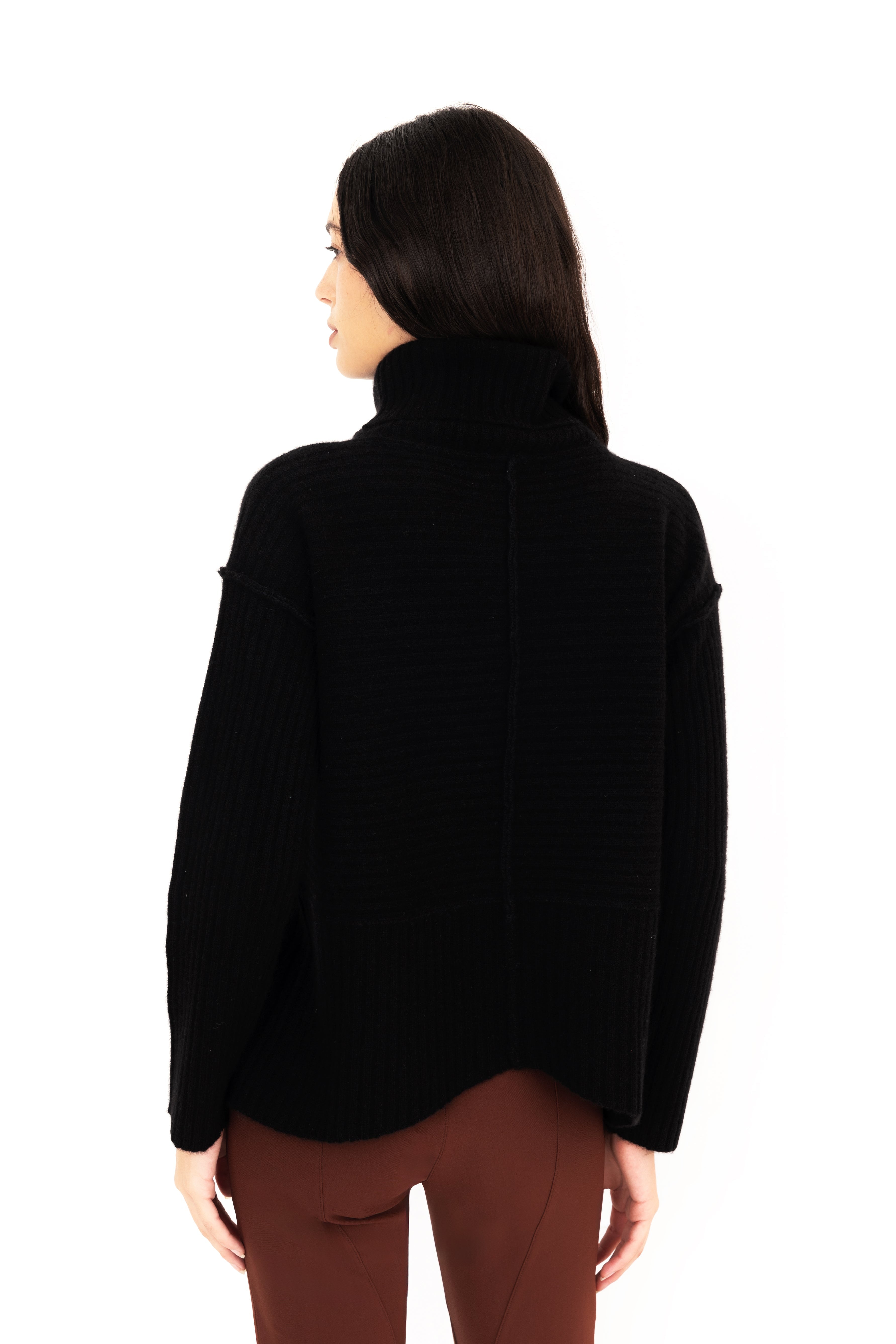 Woman wearing a black turtleneck sweater on a white background