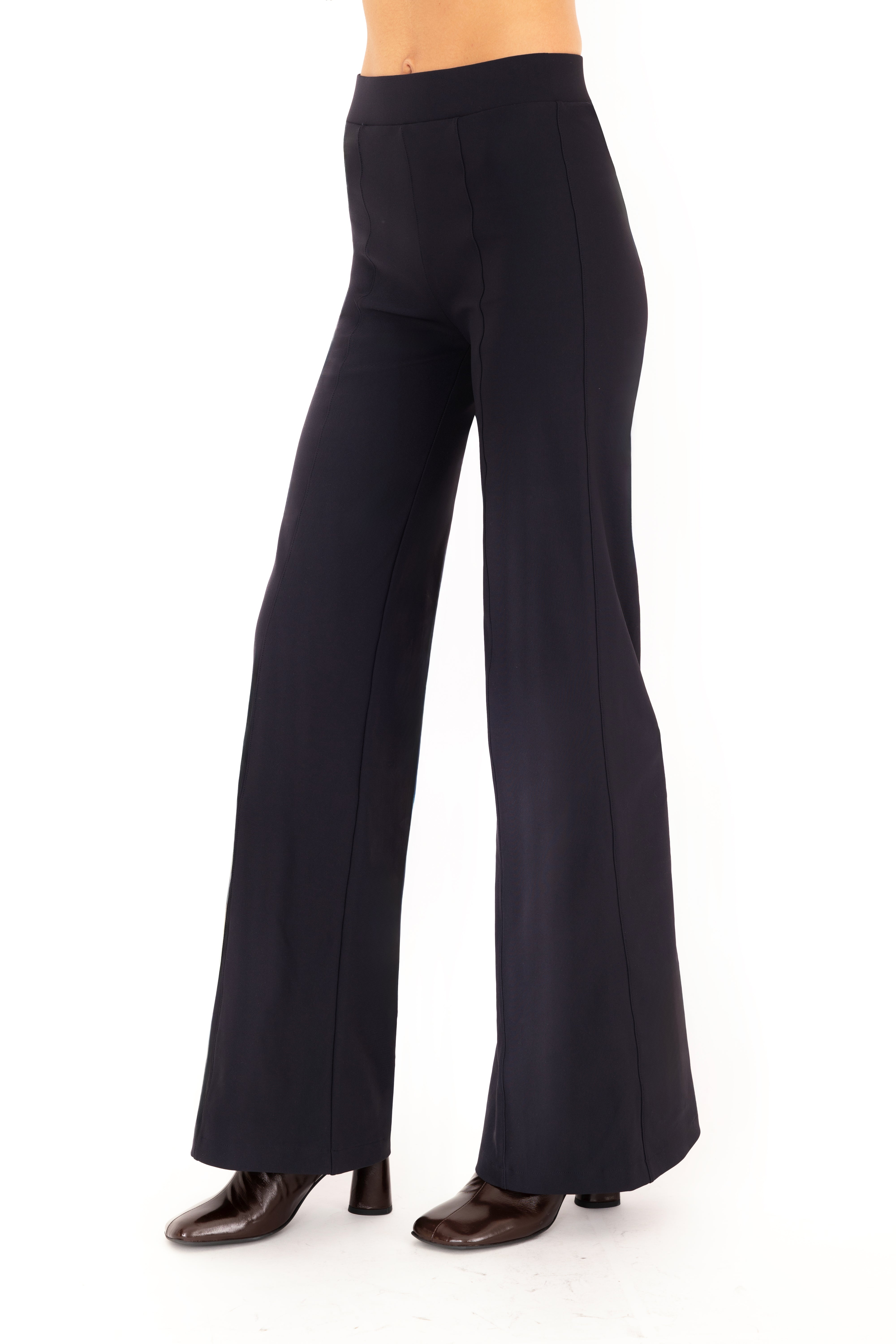 Dark blue pants worn by a person on a white background