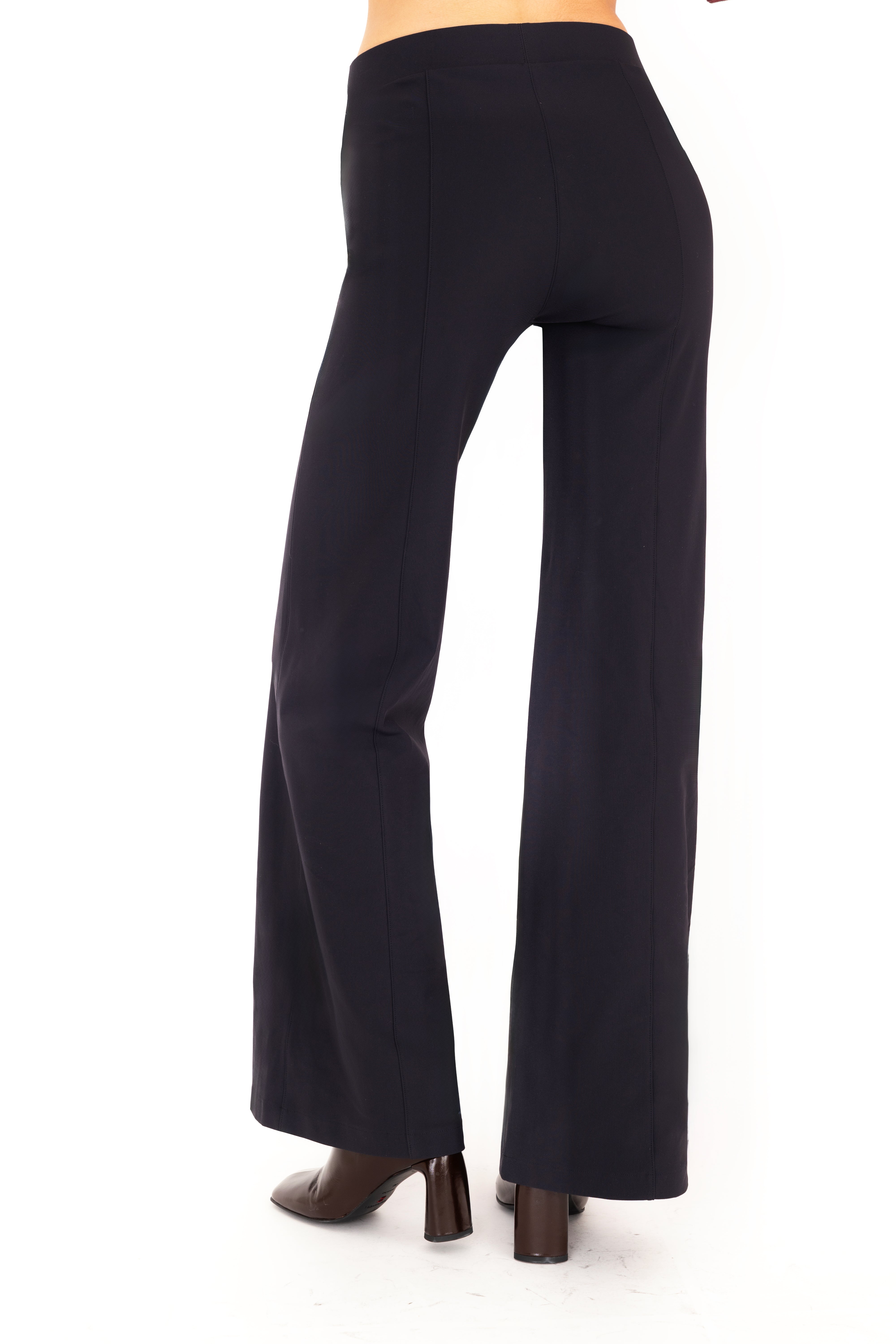 Dark blue pants worn by a person on a white background