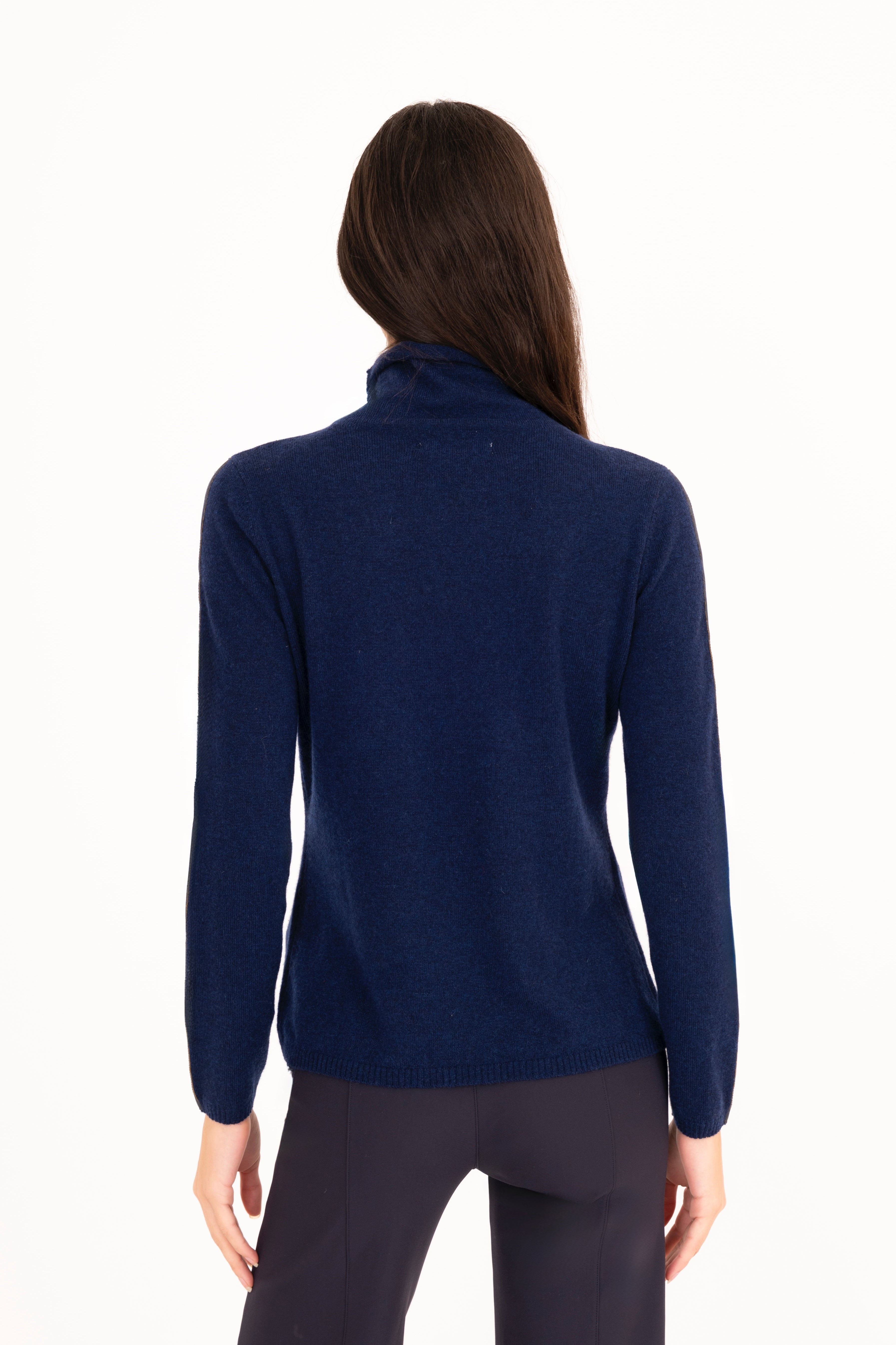 Woman wearing a navy blue turtleneck sweater on a white background