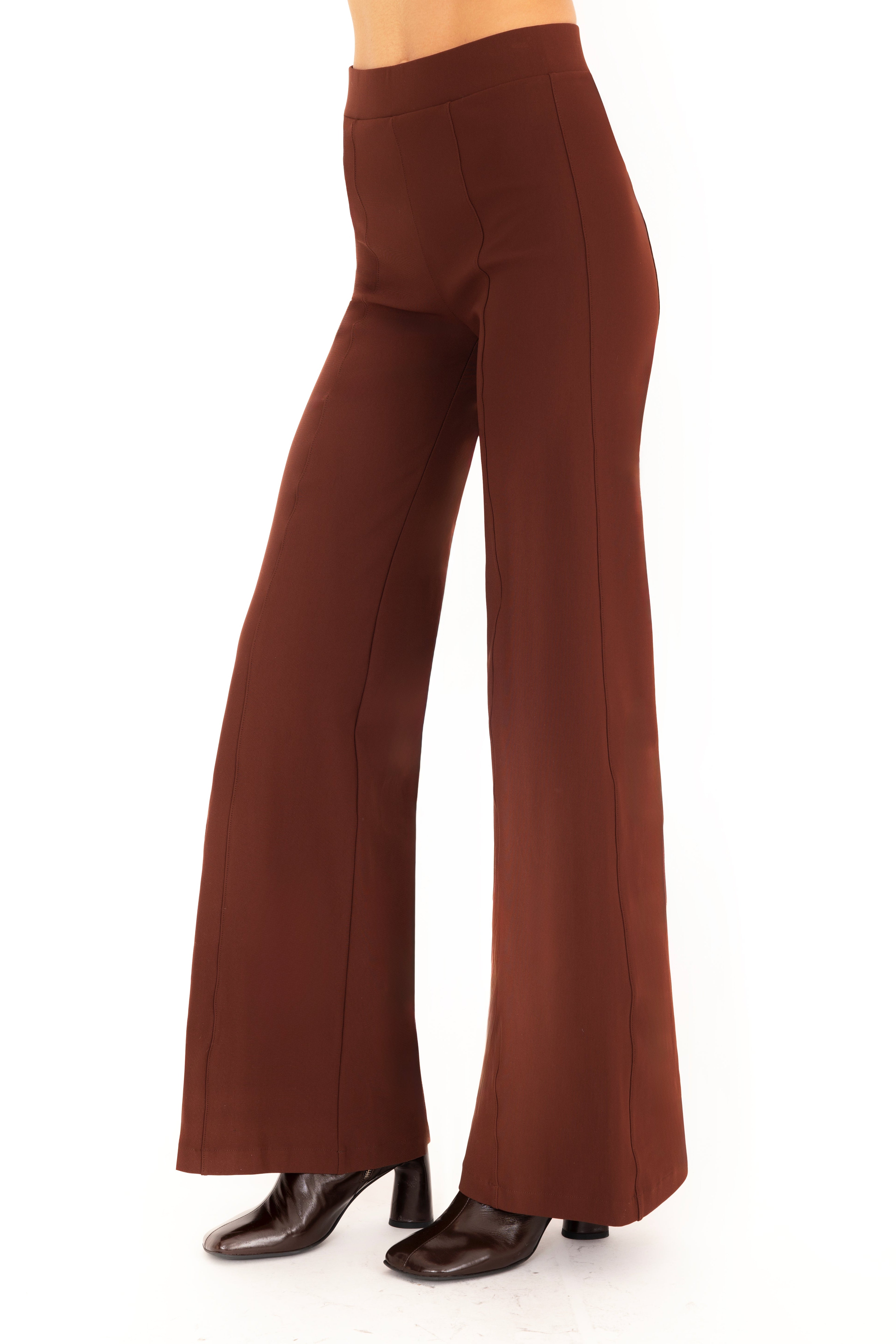 Brown pants worn by a person on a white background
