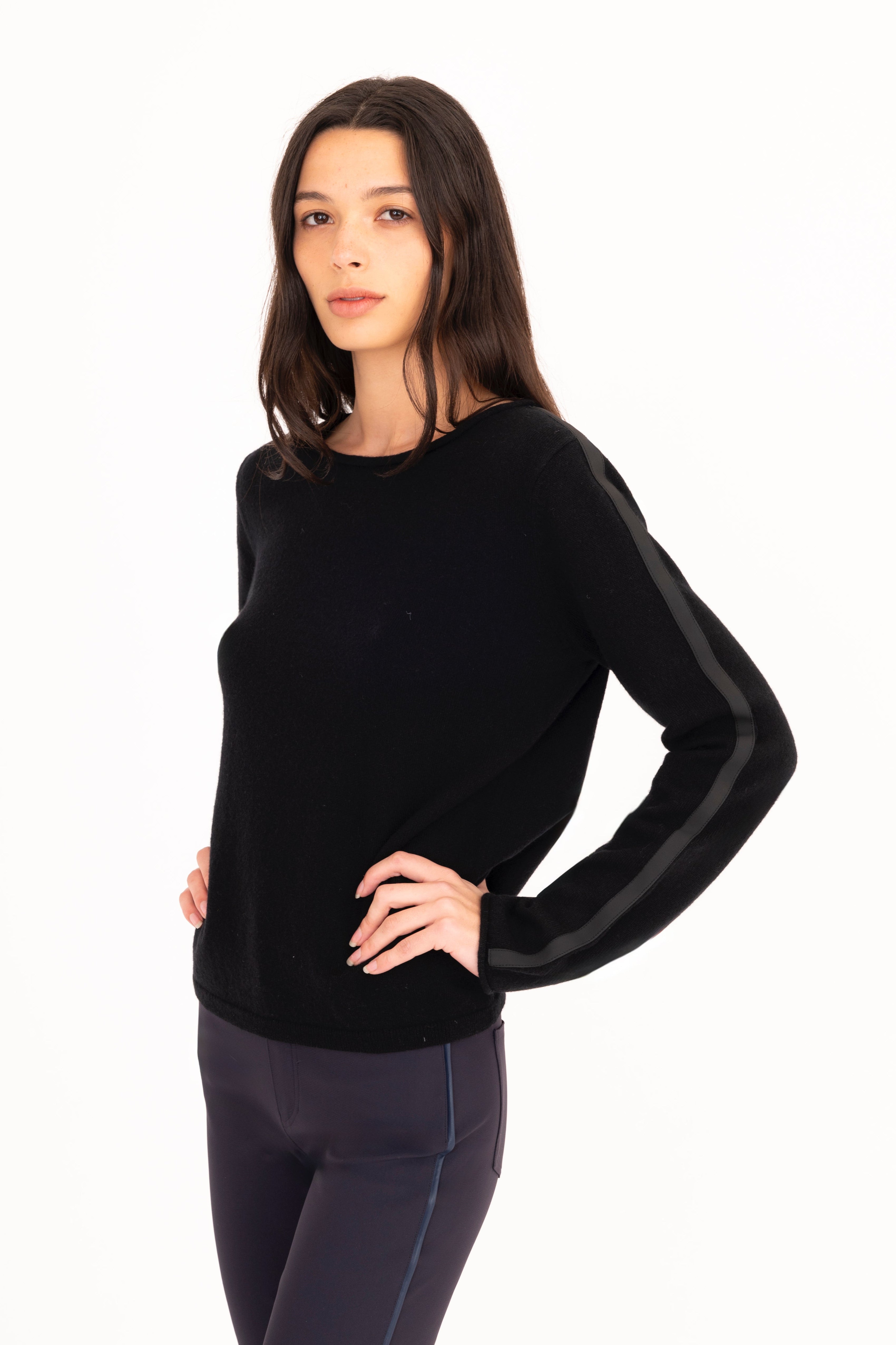 Woman wearing a black long-sleeve top on a white background