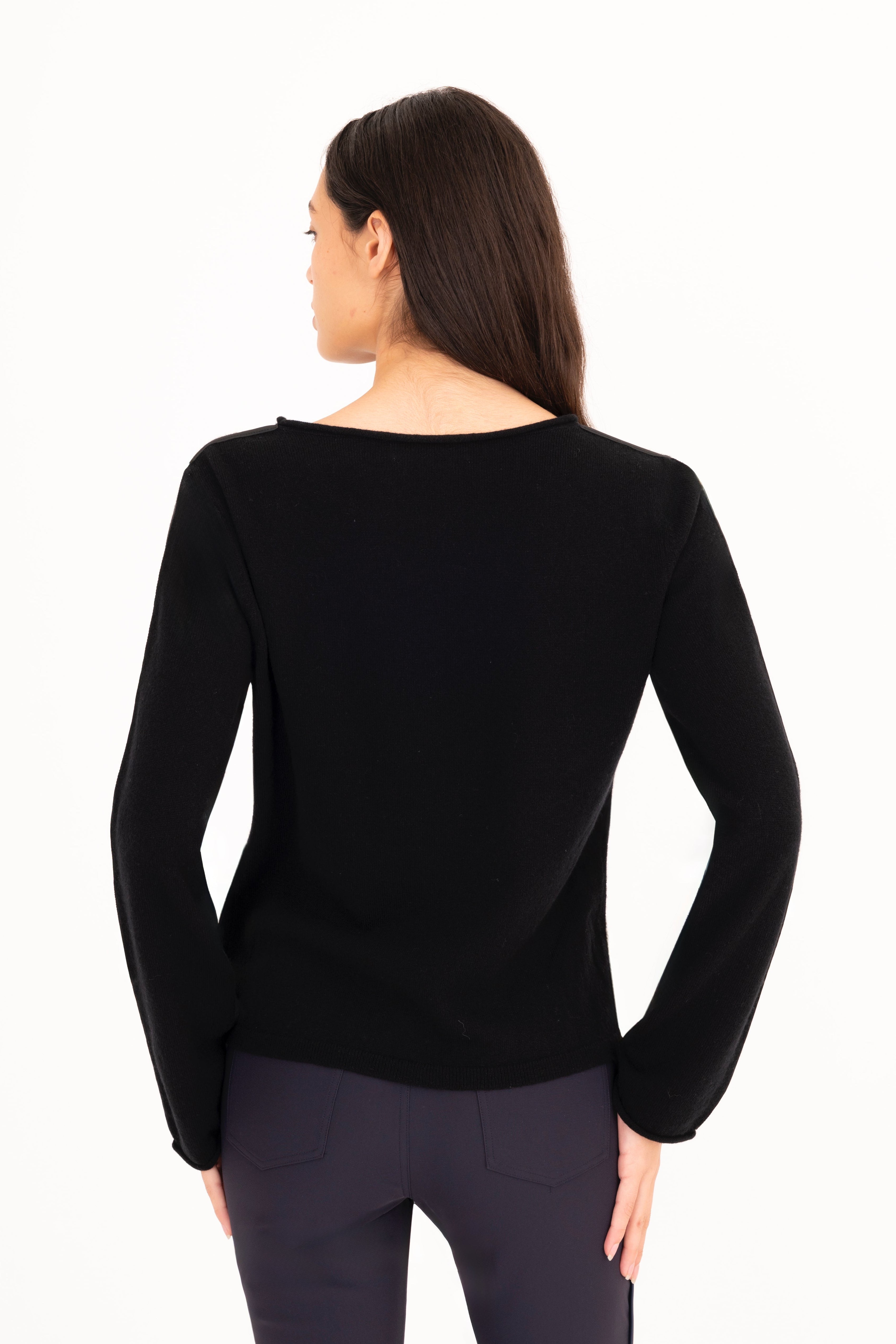 Woman wearing a black long-sleeve top on a white background