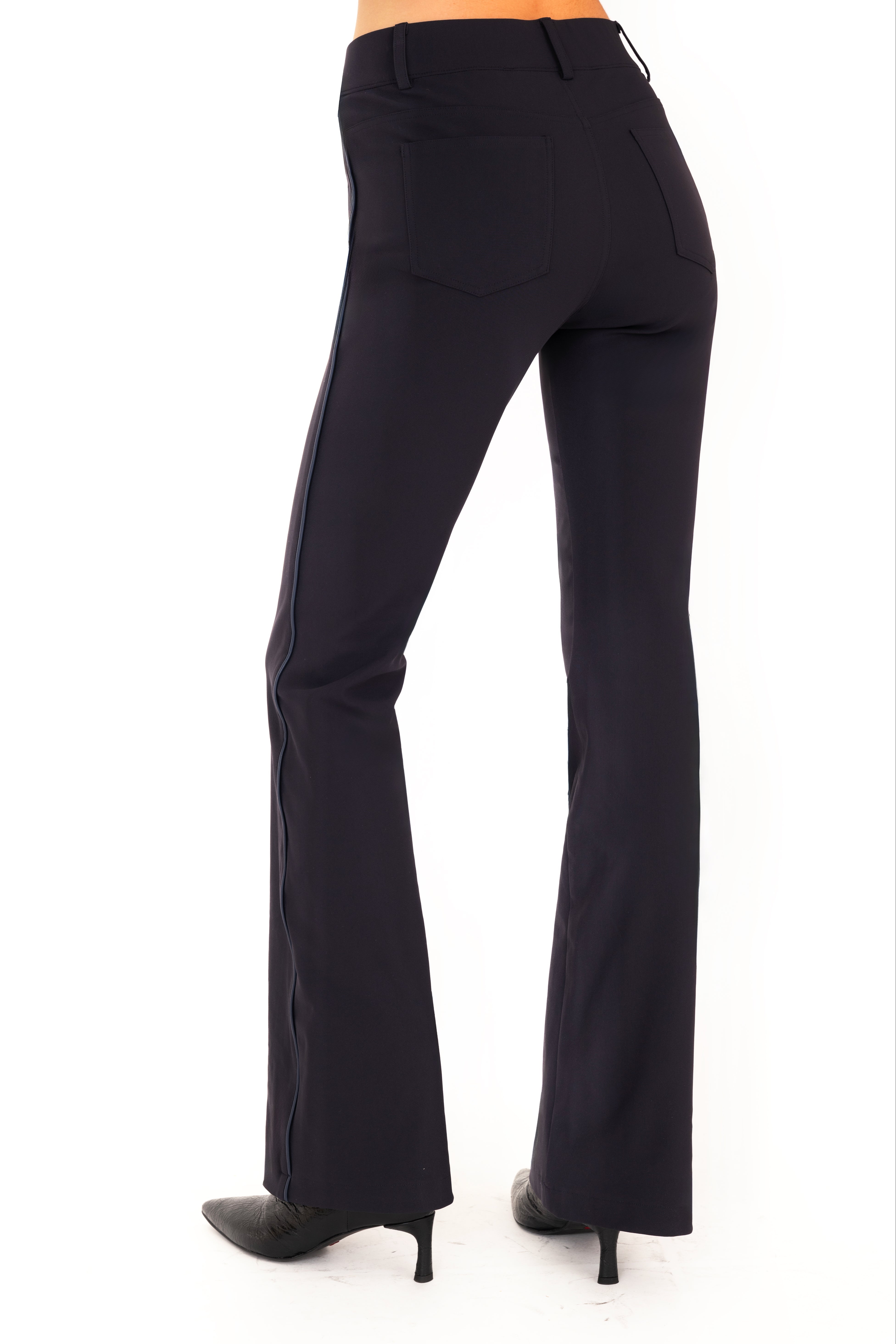 Dark blue pants worn by a person on a white background