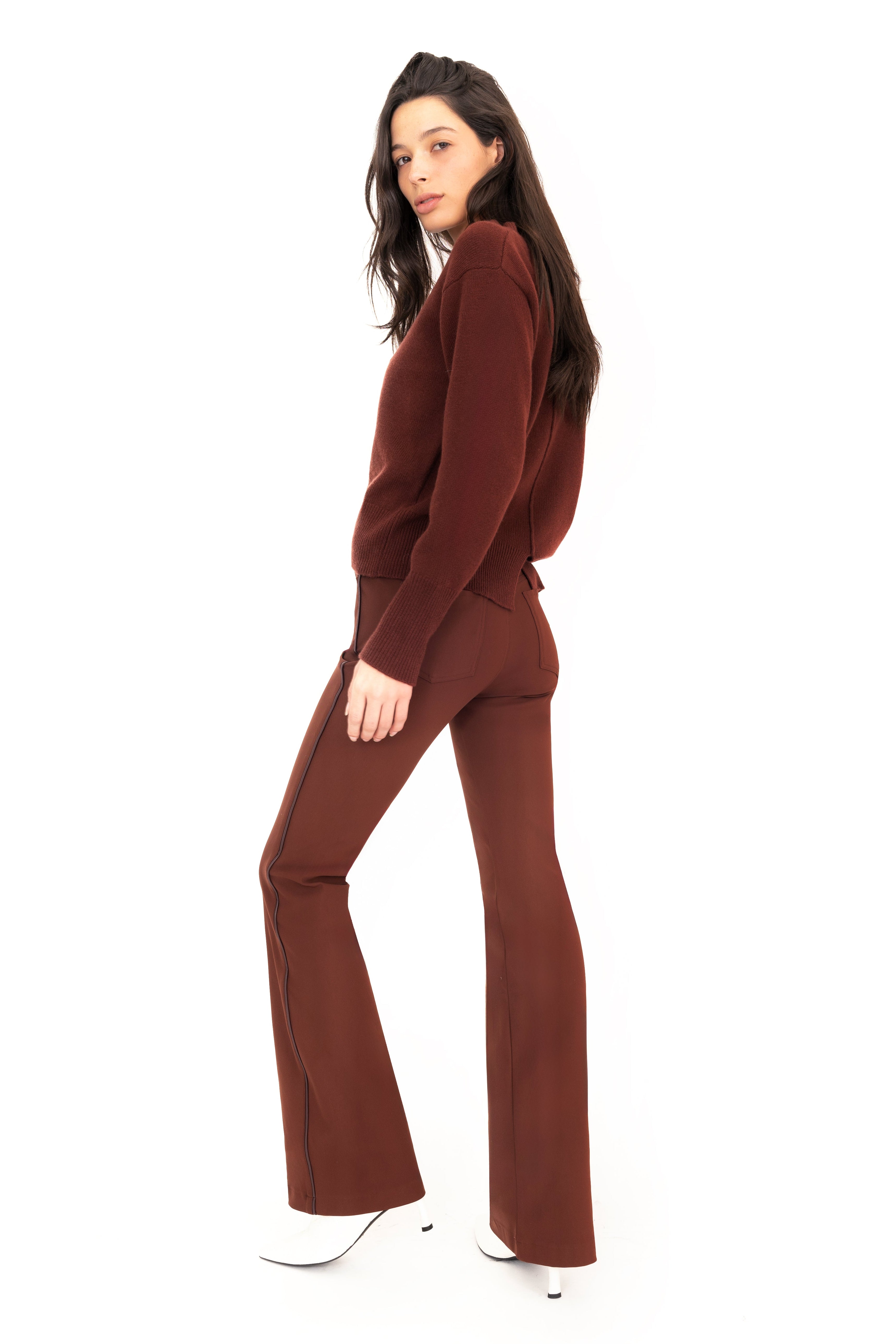 Woman wearing a brown outfit on a white background