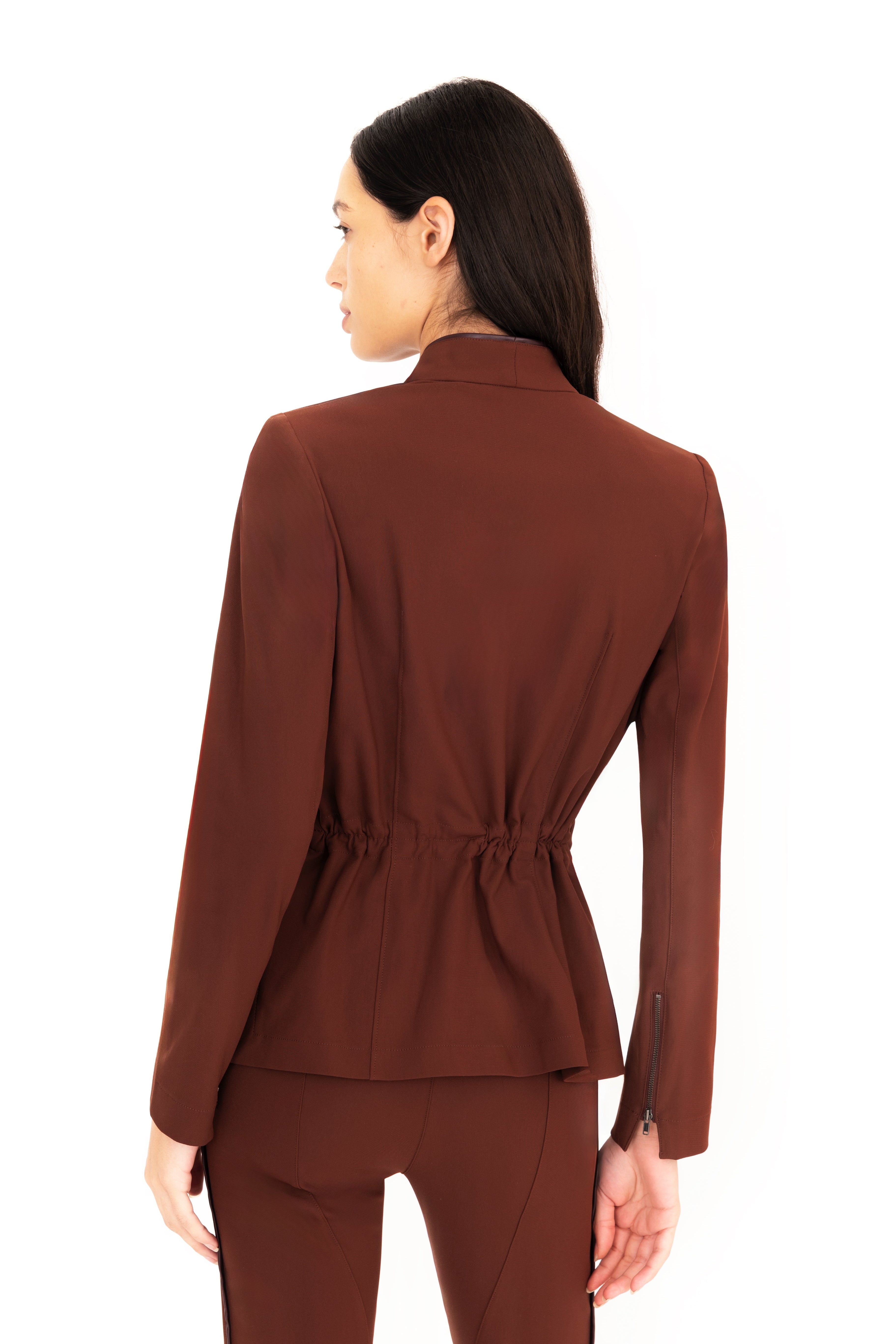 Woman wearing a brown suit on a white background