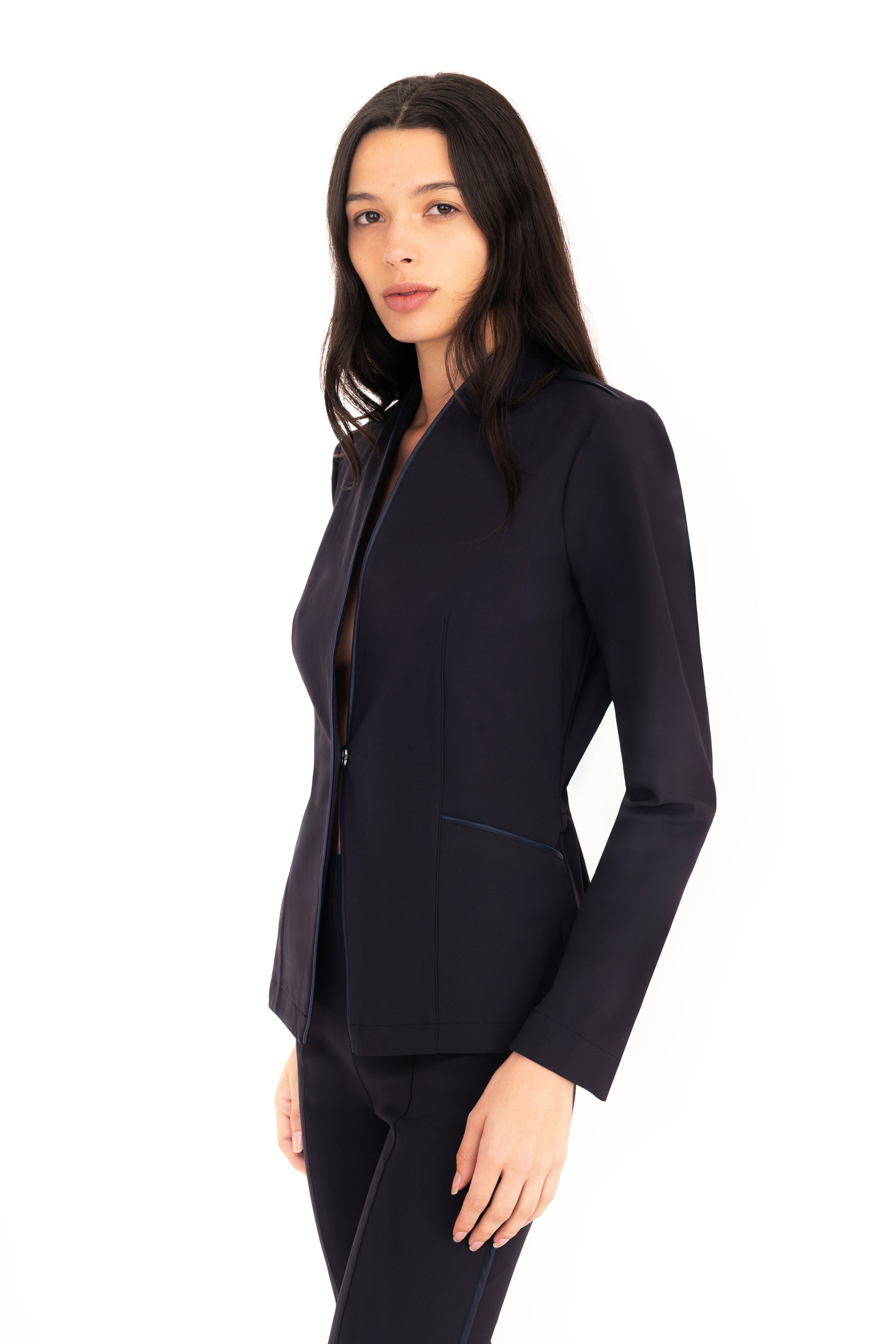 Woman wearing a dark blue suit on a white background