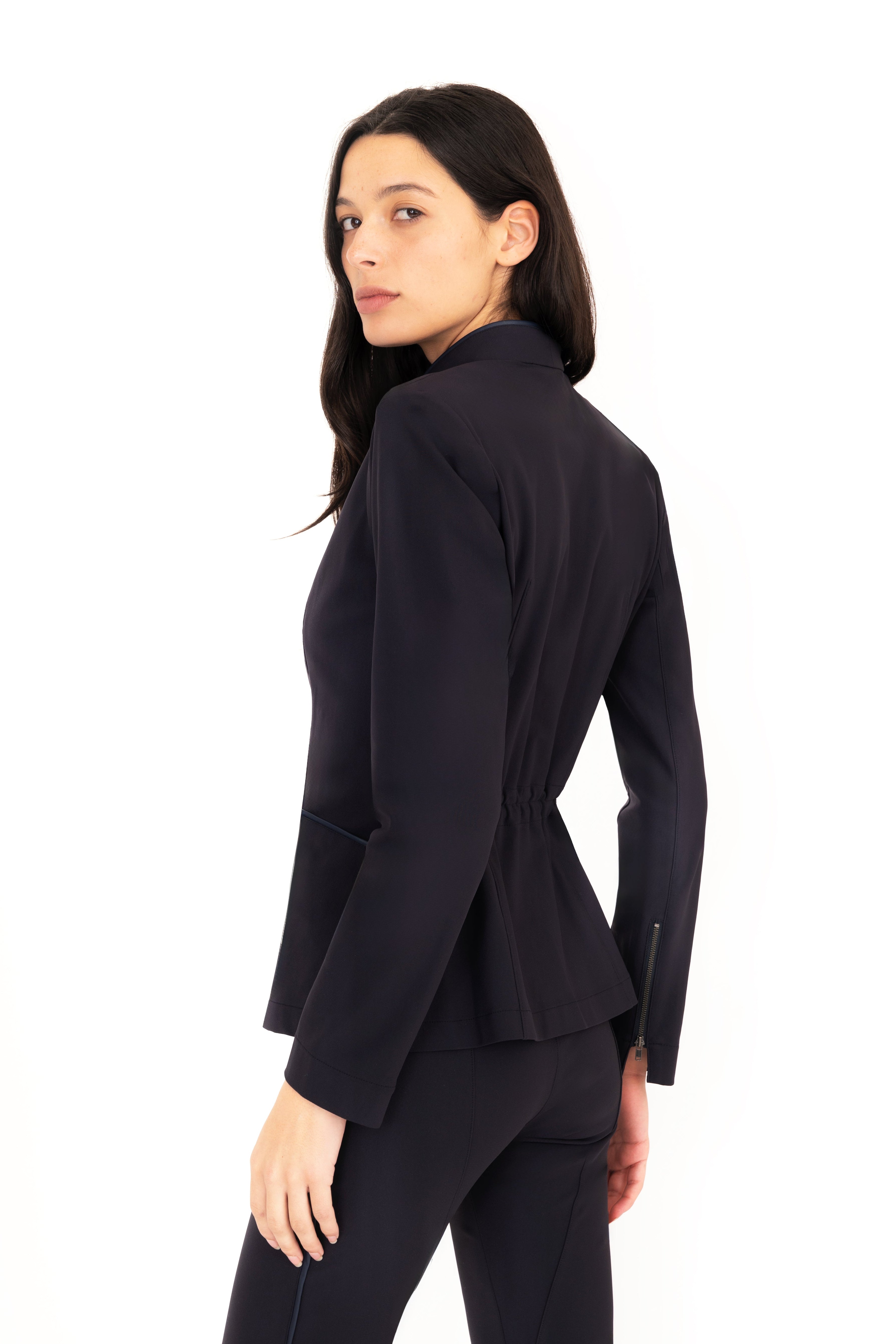 Woman wearing a dark blue suit on a white background