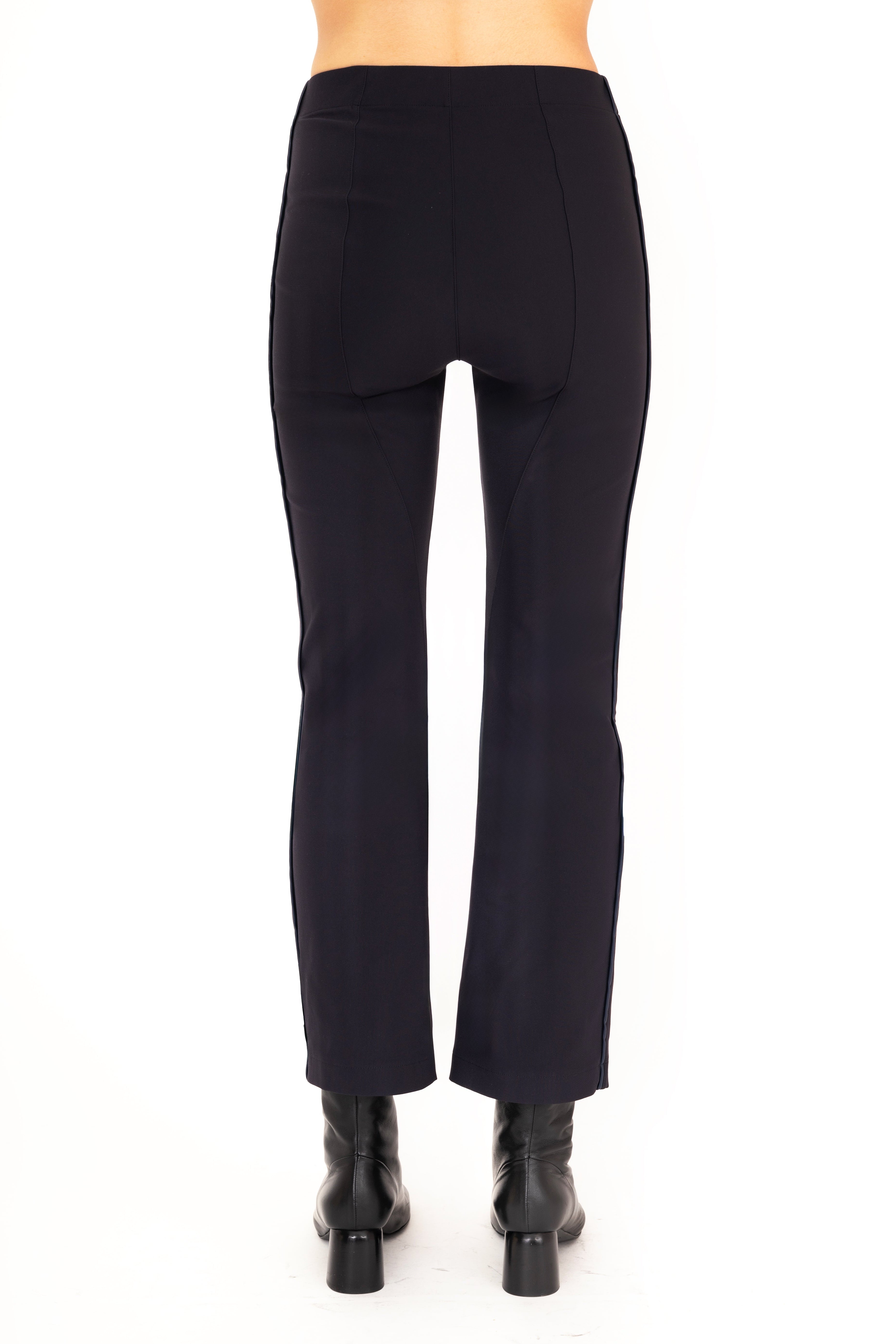 Dark blue pants worn by a person on a white background