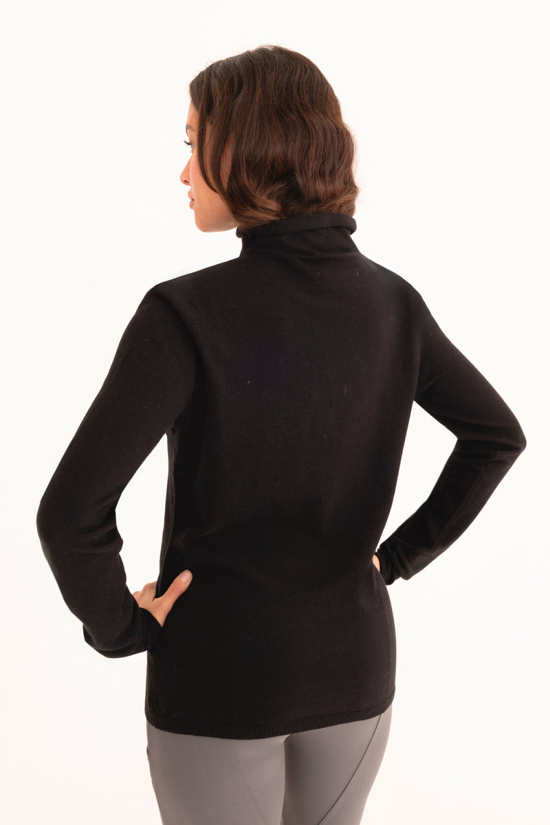 Woman wearing a black turtleneck sweater on a white background