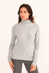 Woman wearing a light blue turtleneck sweater on a white background