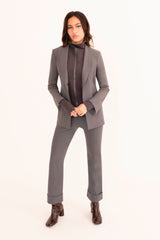 Person wearing a gray suit with a white background