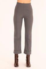 Gray pants worn by a person on a white background